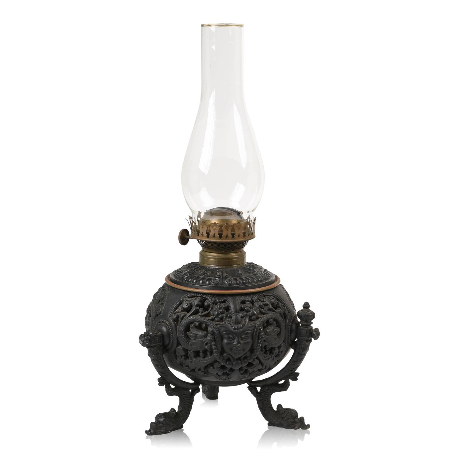 Rococo Revival Patinated-Metal Oil/Kerosene Lamp.: Edward Miller & Company, Meriden, Connecticut, Late Nineteenth Century. The font of spherical form, pierced with Wyverns joined by beaded garlands enclosing masks, raised on scroll supports ending