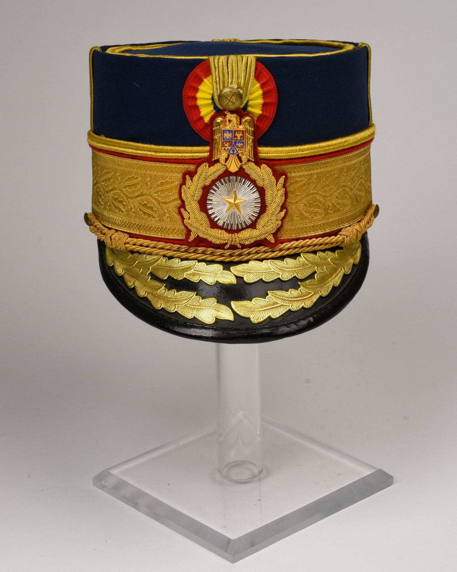 General Officer’s Cap, Romanian Army, c. 2000: Blue cloth body with gilt lace and trimmings, national cockade and patent leather visor.