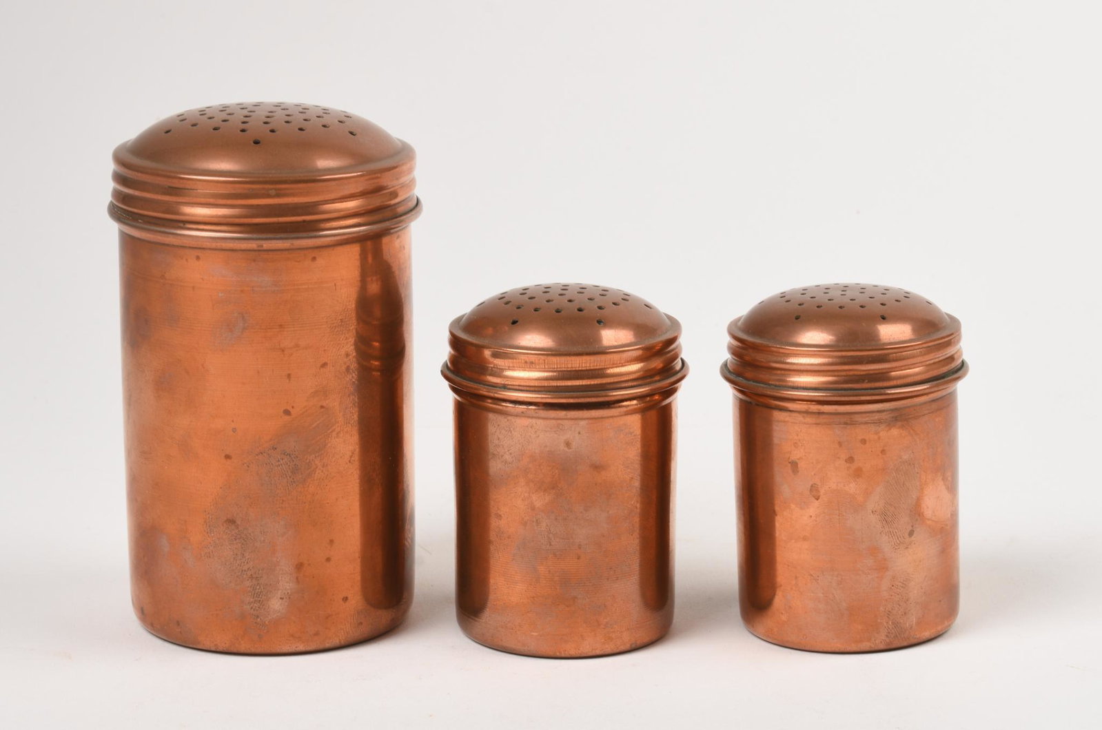 Three Charles Ruegger Copper Shakers.: Heights 5 and 3 inches.