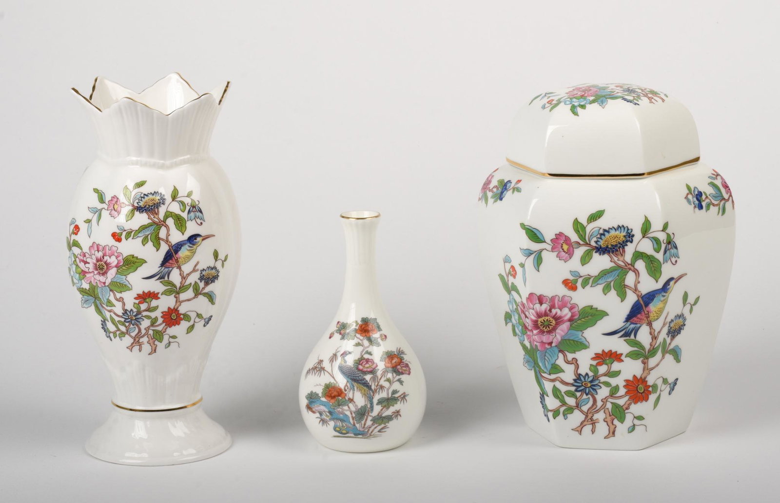 Four Floral Decorated Ceramic Pieces.: An Aynsley Pembroke lidded jar, height 8 inches, Aynsley Pembroke vase, Wedgwood Kutani Crane Vase, and a Limoges plaque.