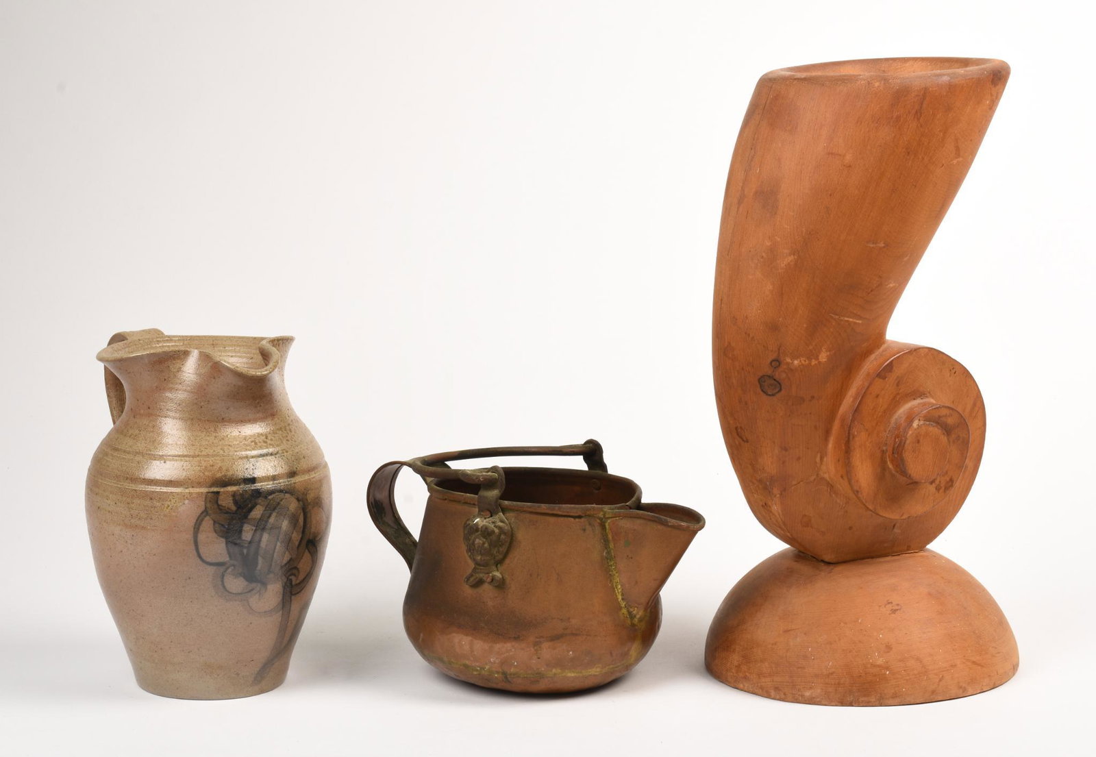 Three Decorative Objects.: Large carved wooden vase, height 13.25 inches, a pitcher, marked Clay Sample at base, height 8 inches, and a copper kettle.