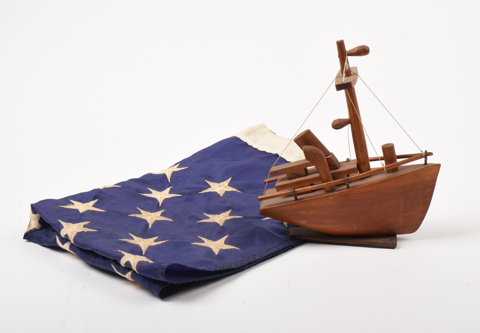 50 Star Penant and a Carved Wooden Ship.: Penant 16 x 22 inches.