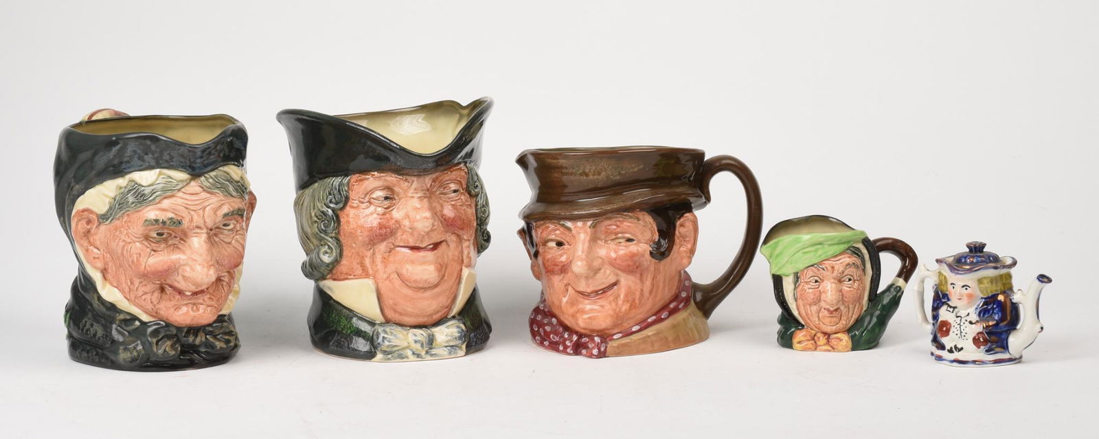 Four Royal Doulton Figural Pitchers. (1 of 2)
