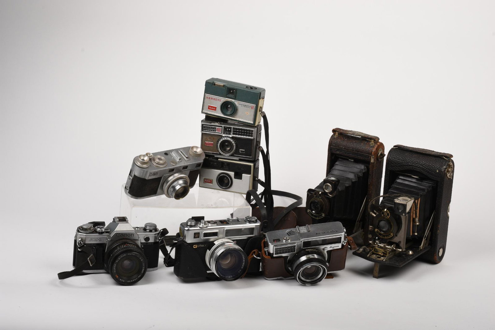 Collection of Vintage Cameras.: Canon AE-1 with Super Albinar 28mm f2.8, Clarus MS-35, Fujica 35-SE, Yashica Electro 35, Kodak No. 3 Autographic, and others. All untested, sold strictly as-is.