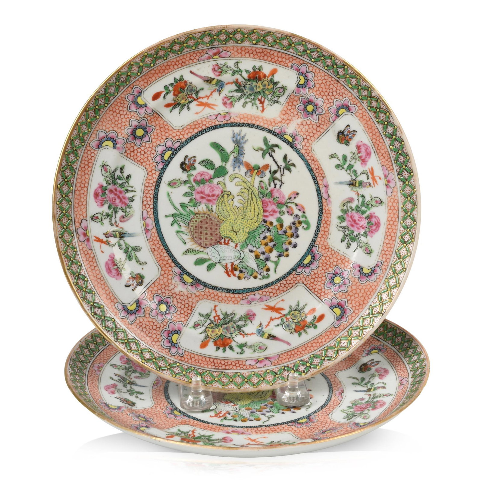 Pair of Chinese Famille Rose Plates: Each with central panel of fruits, flowers and insects, each also with four panels with flowers, insects and birds against an unusual faux sharkskin red ground, 19th c., diameter 8.5 inches.