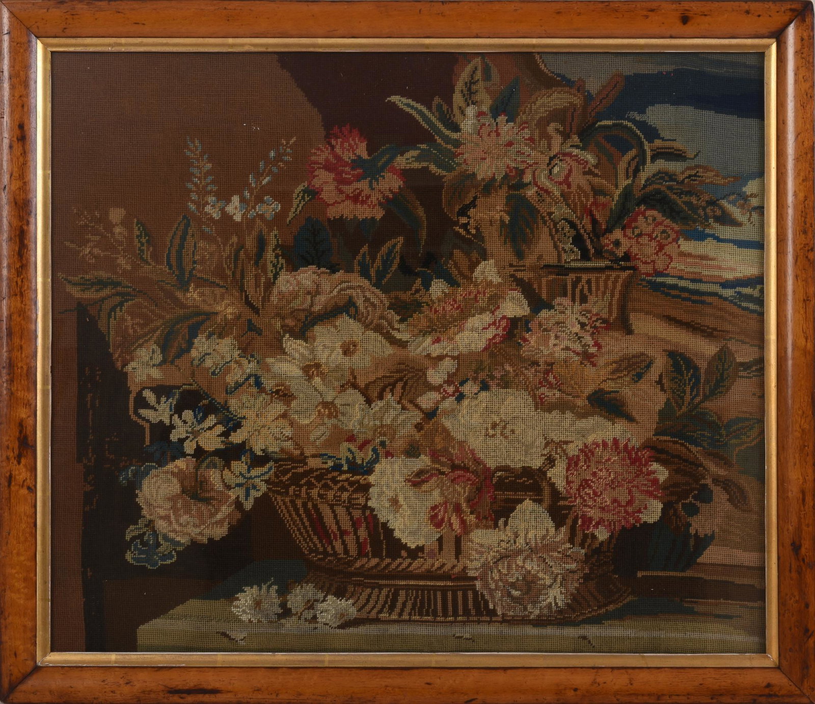 Needlepoint of a Basket of Flowers.: In a bird's eye maple frame, 21 x 24.5 inches, needlework 19 x 22.5 inches.