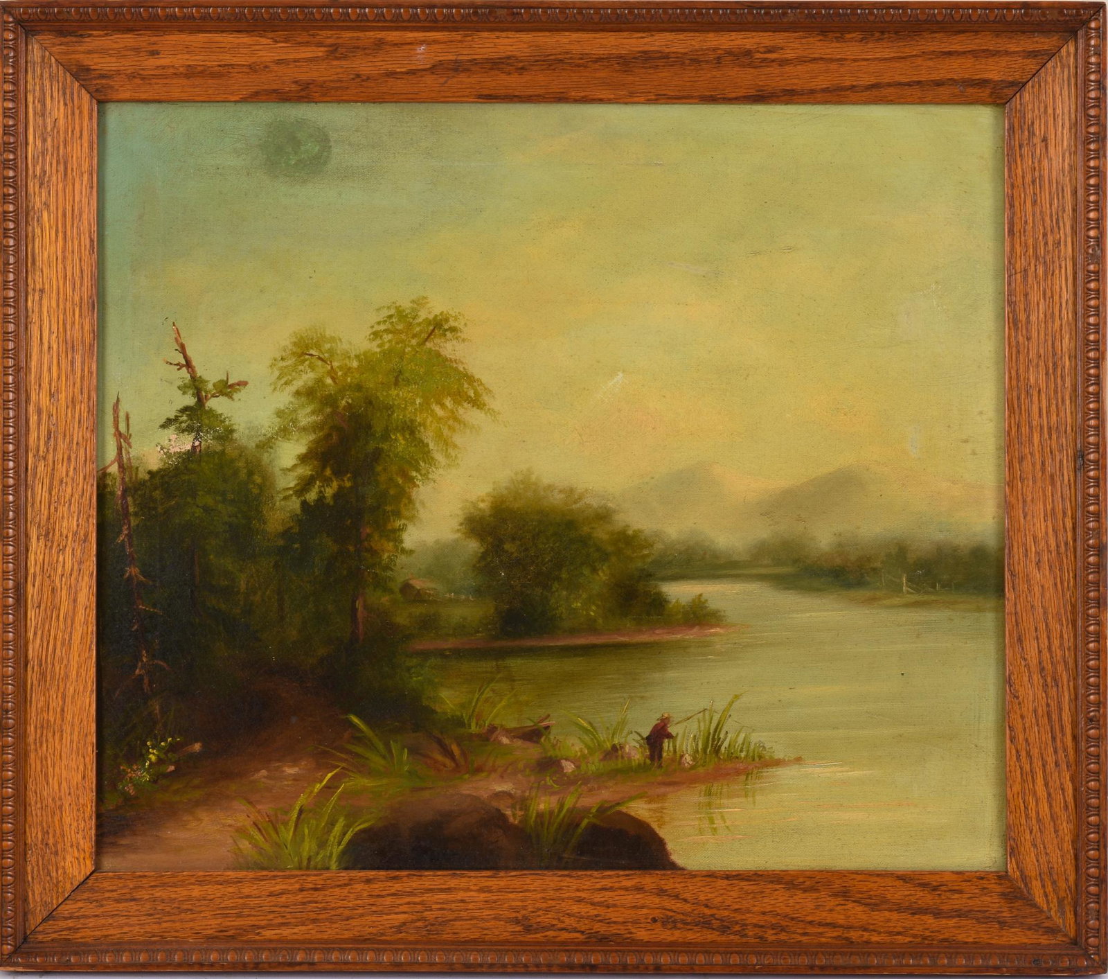 American School Painting of a Man Fishing in a Landscape.: Oil on canvas, 17 x 20 inches. In an oak egg frame with egg and dart molding.