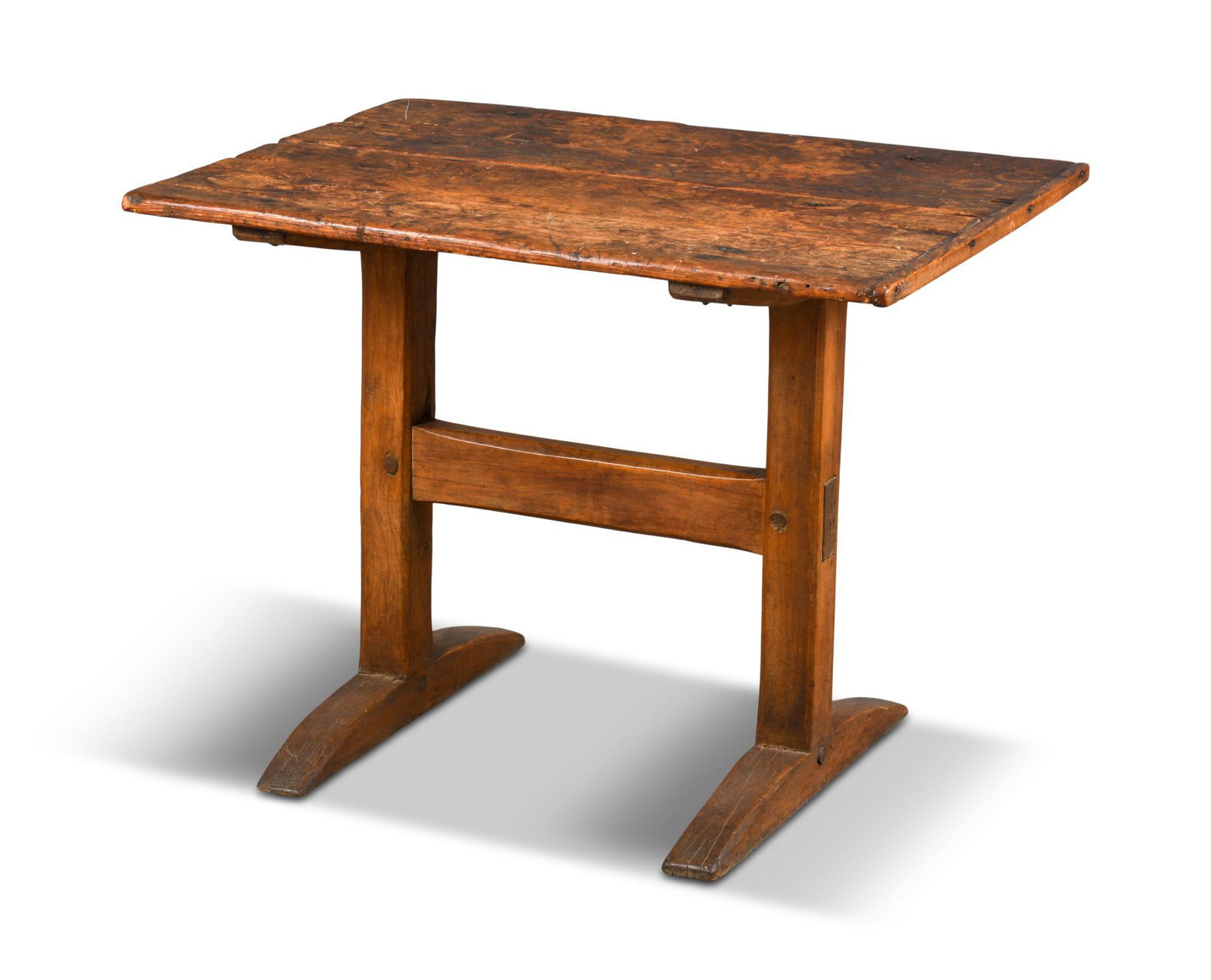 Small New England Trestle Base Table.: Circa 1700-80, white pine and maple. Height 27.25 inches, top 35.5 x 25.5 inches. Literature: Illustrated in New England Furniture at Williamsburg by Barry A. Greenlaw, figure 114. Provenance: Colonia