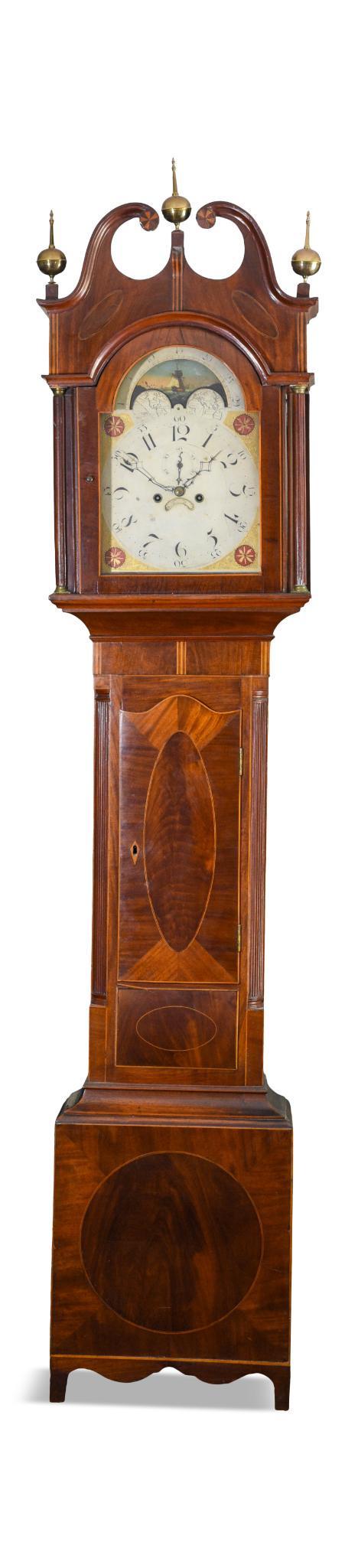 New Jersey Tall Case Clock by Joakim Hill.: The bonnet with split pediment, pinwheel inlay, and fluted columns on a case of inlaid mahogany. Signed Joakim Hill, Flemington, New Jersey. Height including finials 92 inches, width at base 17.5 inch