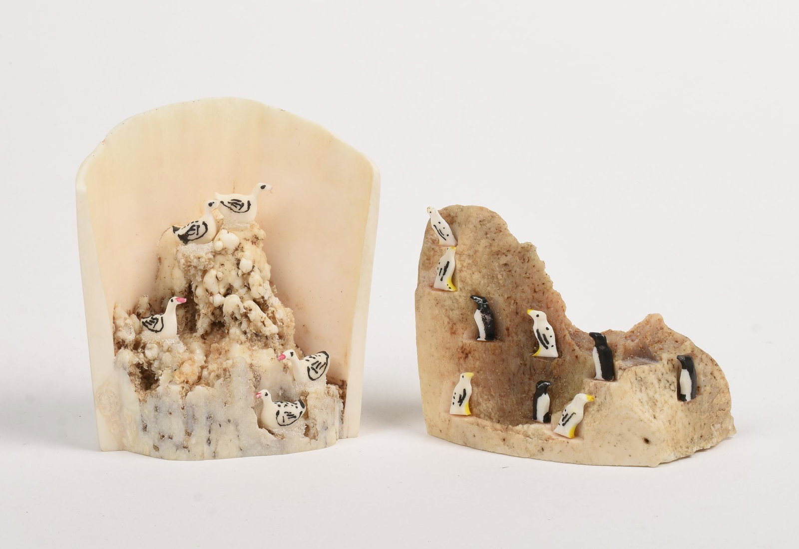 Two Inuit Bone Carvings.: One with sea birds, signed John S. Penatac, height 3 inches. The other with penguins, signed R. Sirloak, height 2 inches.