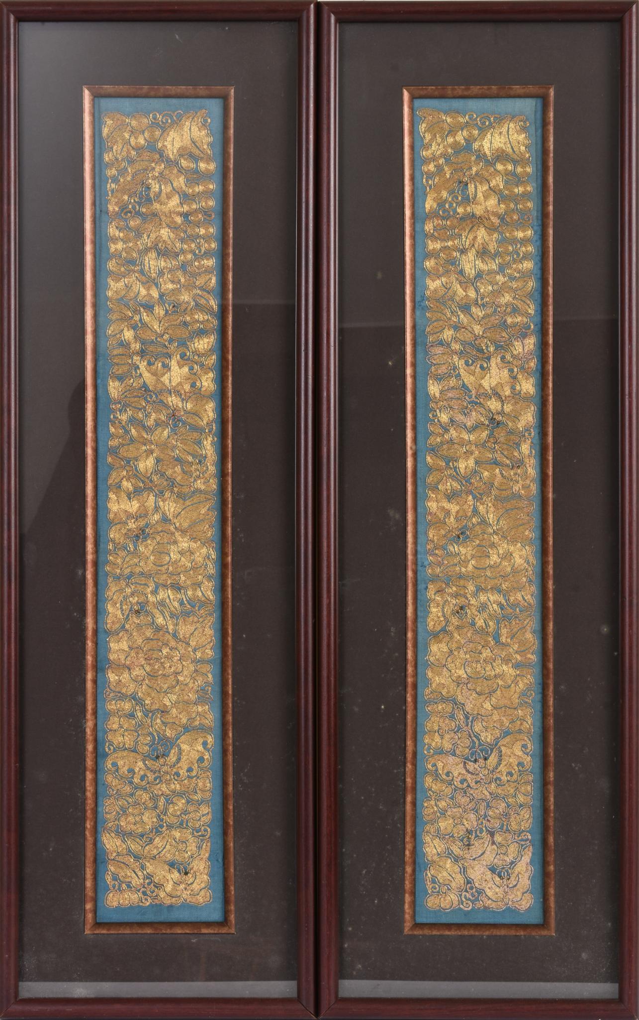 Pair of Chinese Embroidered Textile Panels.: Each richly embroidered with butterflies and flowers in gilt thread on a blue ground, 19th c., framed, each frame 29.5 x 9.5 inches.