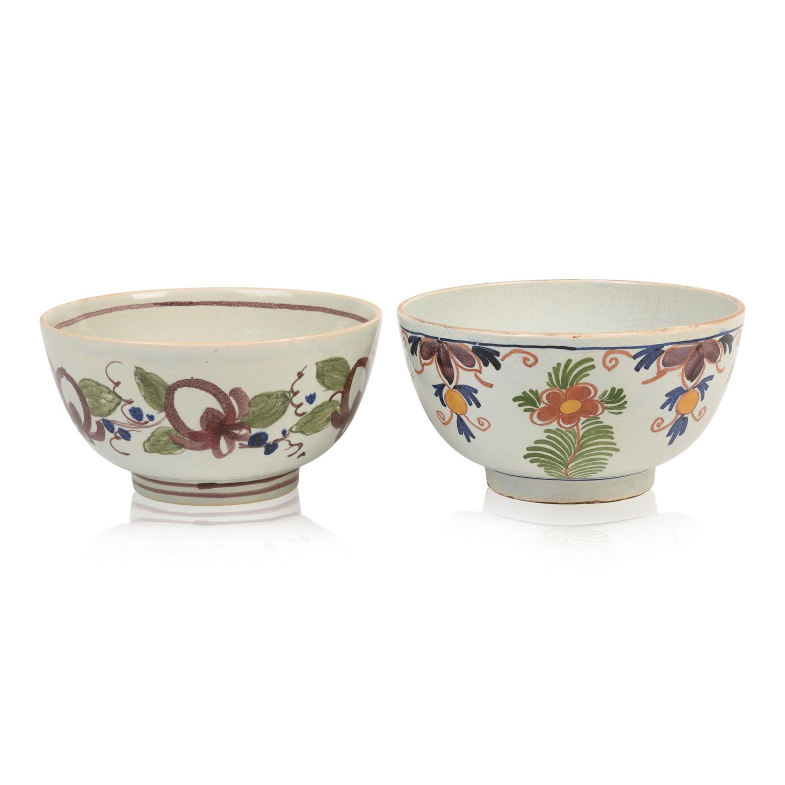 Two Delft Bowls: Each with floral decoration, one with indistinct mark on bottom, 19th c., diameters 7.125 inches.
