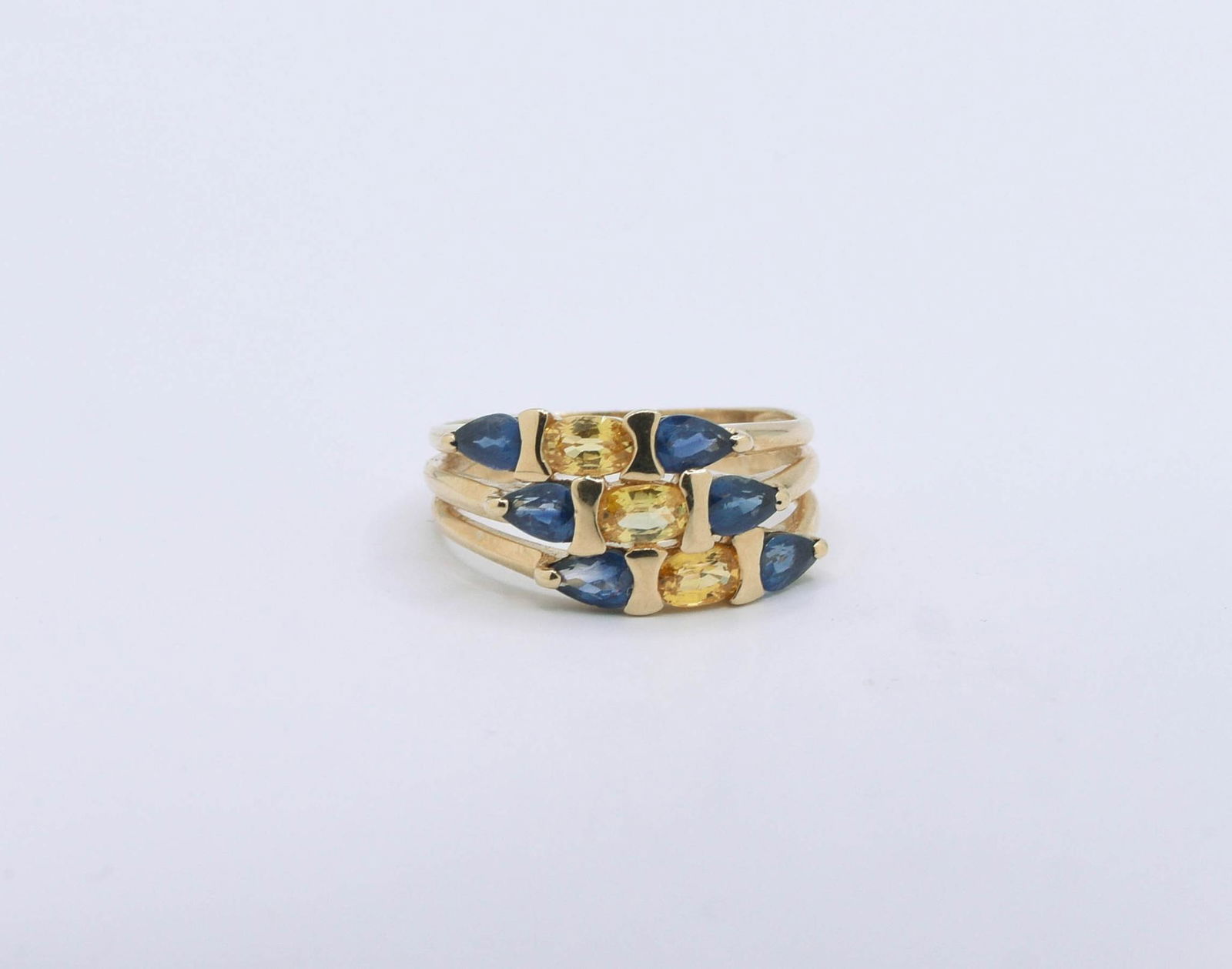 10K Yellow Gold Blue & Yellow Sapphire Ring: 6) 5mm X 3mm Pear Blue & 3) 5mm X 3mm Oval Yellow Sapphire Ring 3.5 grams. Size 7.5