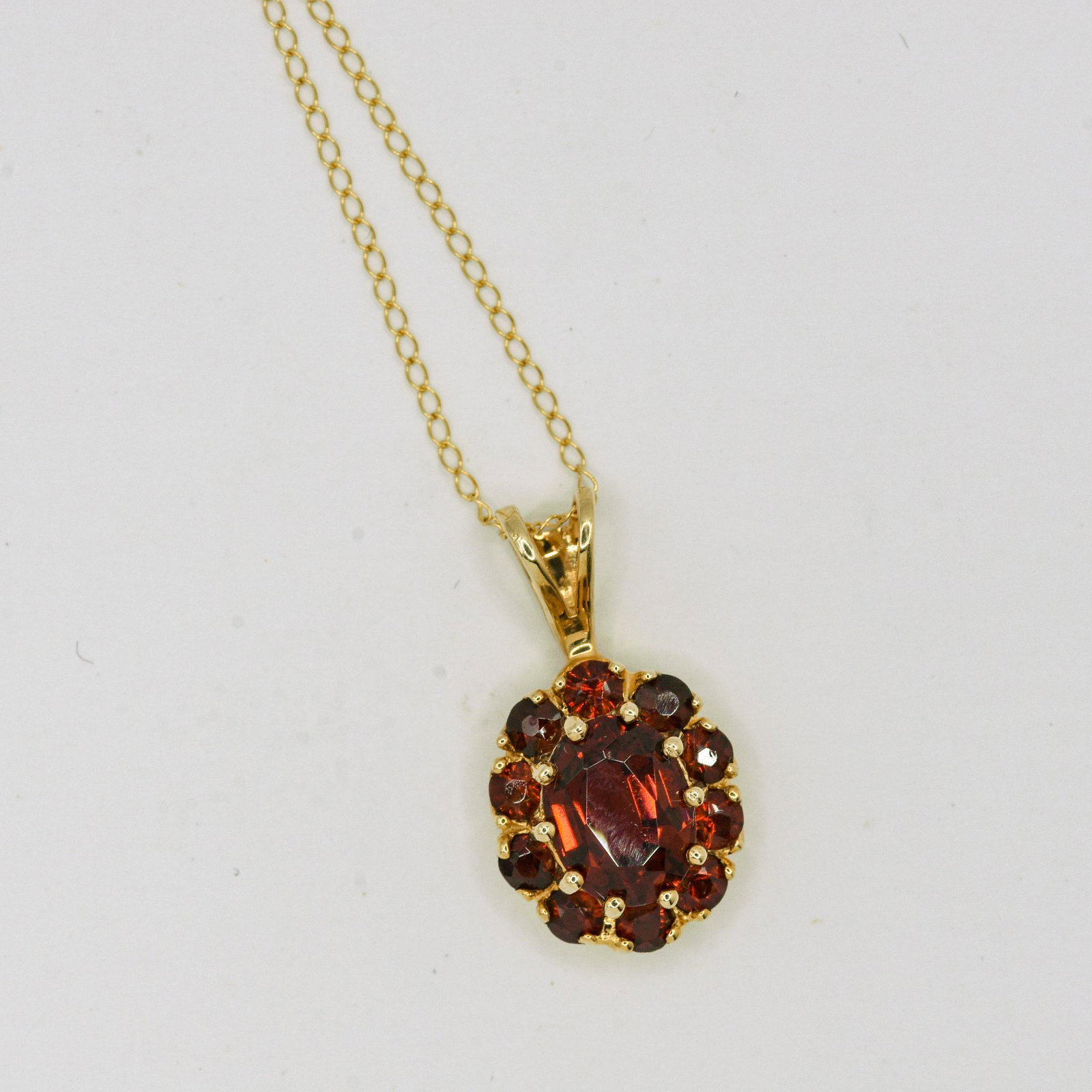 14K Garnet Pendant Necklace: 8mm X 6mm Oval & 20 Round Garnet Pendant Necklace, 2.4 grams