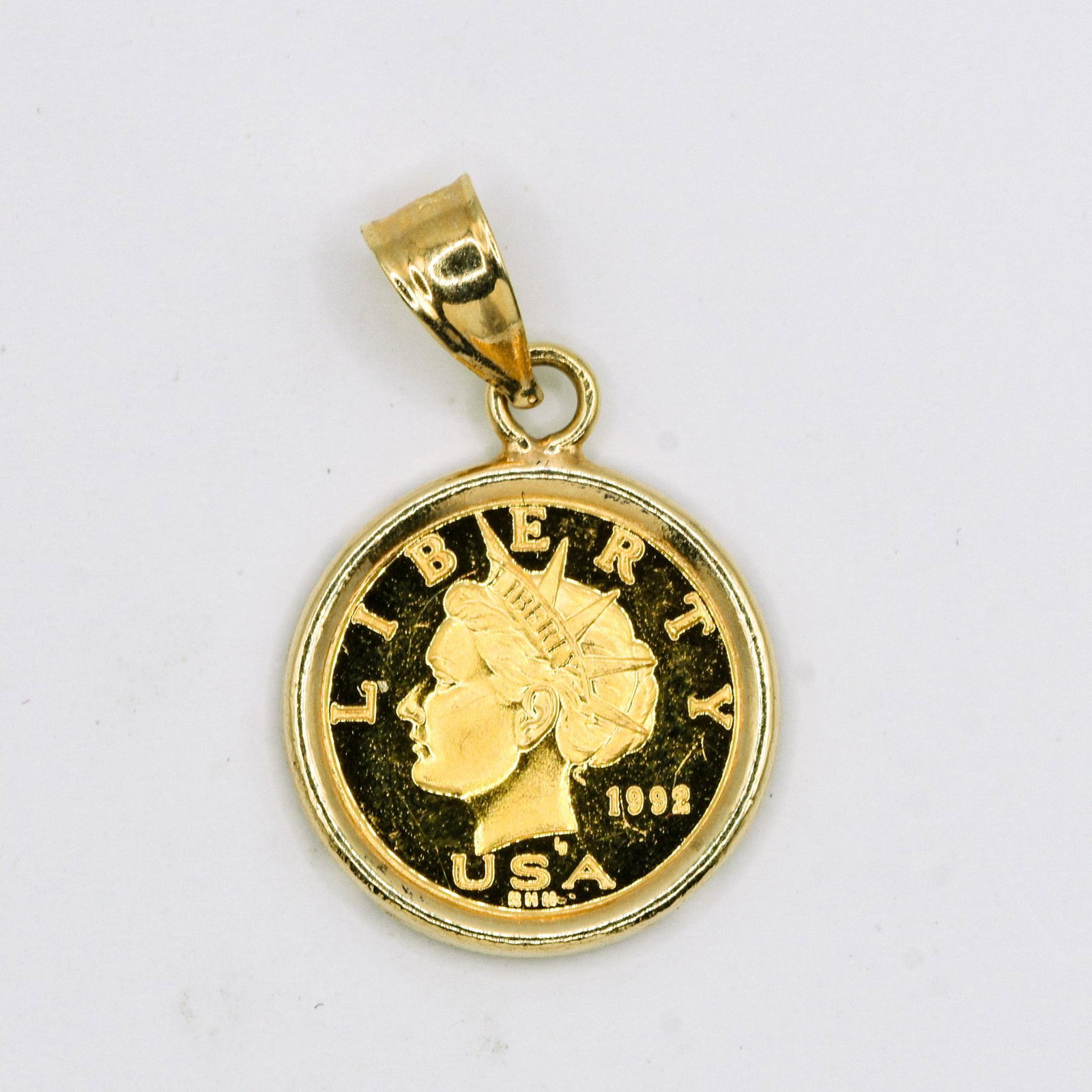 1992 1/20 Gold Liberty Miniature Coin Pendant: Coin rest in 14K Coin Holder, 2.1 grams
