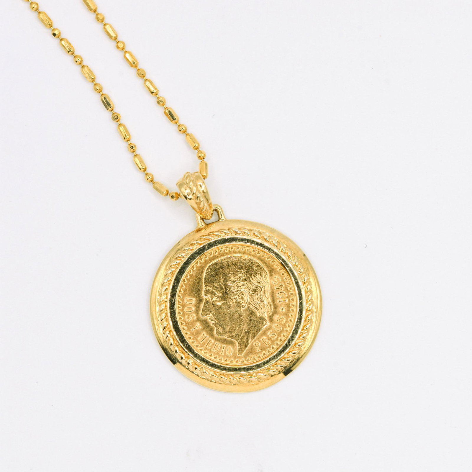 1945 Mexican 2.5 Peso Gold Coin Pendant: Coin rests in 18K Coin Holder on 18" 18K Chain, 7.9 grams