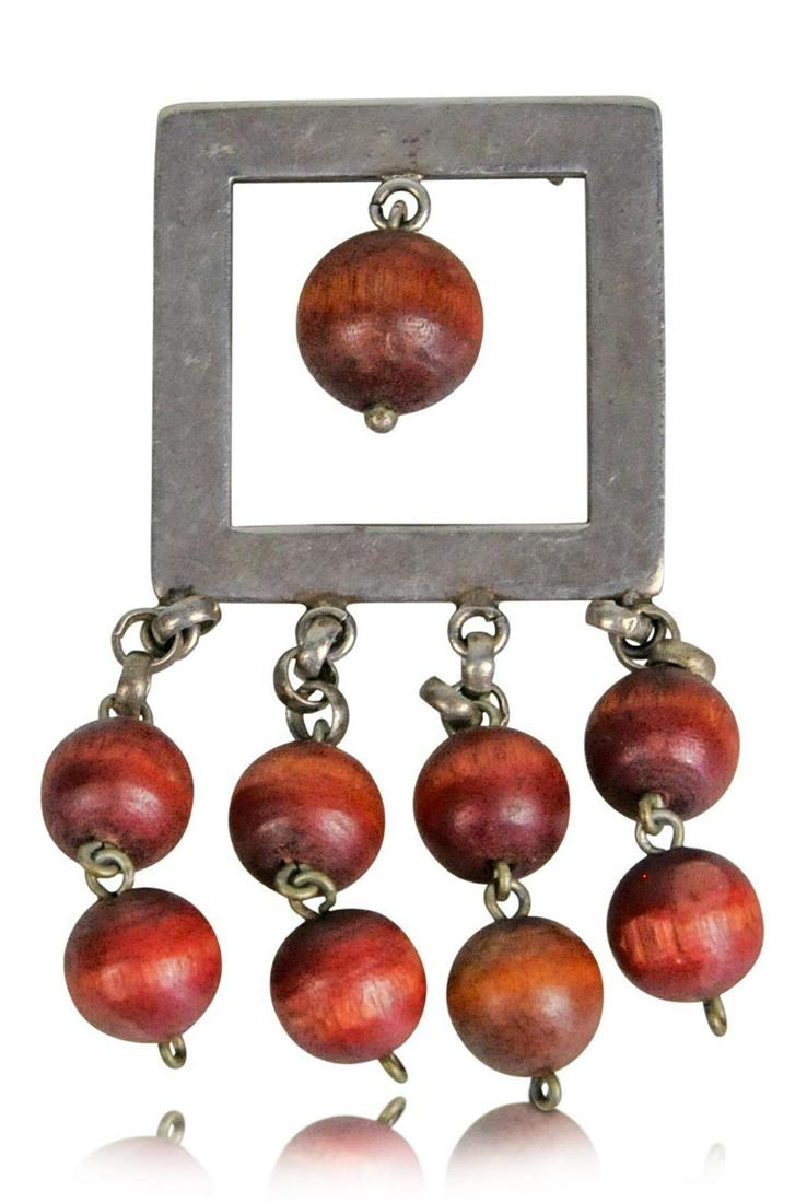 Kaija Aarikka Modernist Kinetic Pin: Silver metal and dangling wood beads, Finland, c. 1960. Height including beads approximately 2.5 inches.