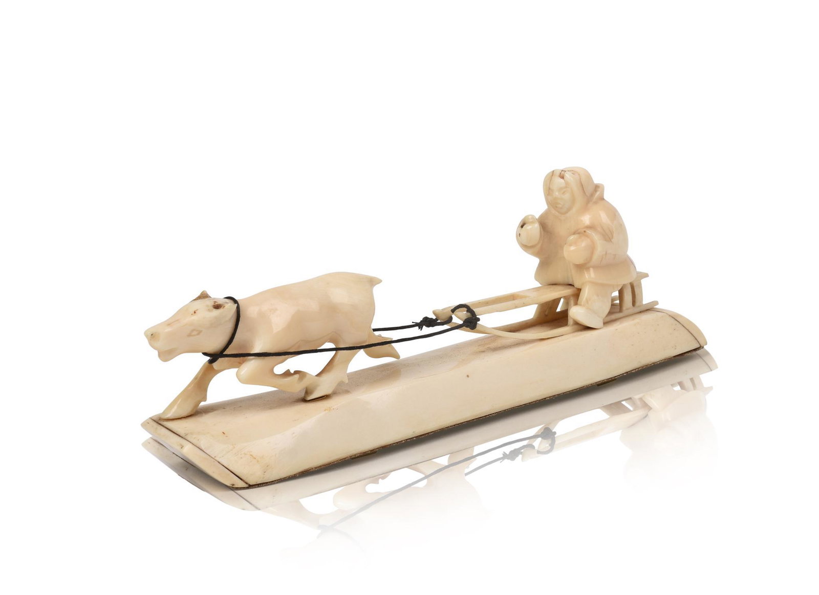 Inuit Carved Walrus Tusk Sled Dog and Sled.: Length 9 inches.