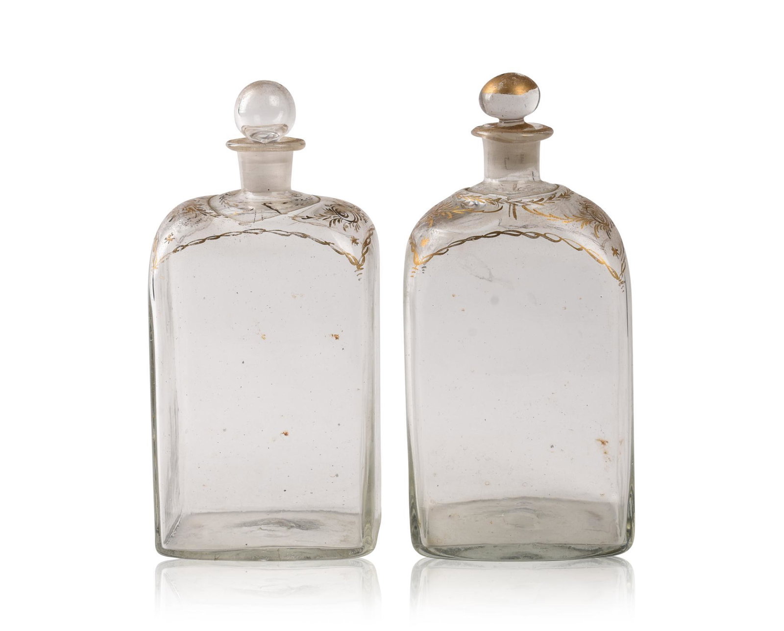Pair of Gilt Decorated Glass Decanters.: 18th Century, height 8 inches. One with replaced stopper.