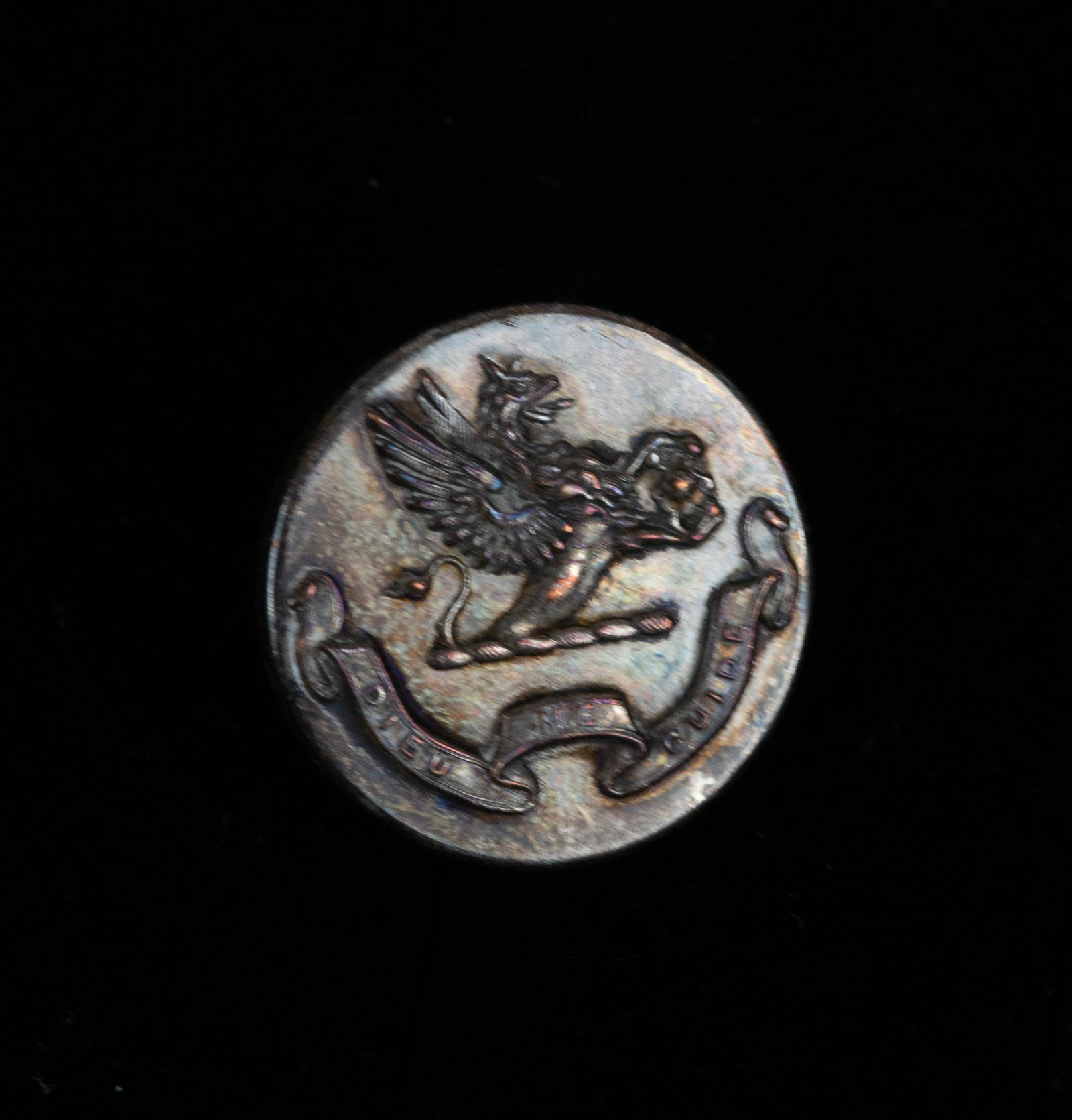 ANTIQUE TIFFANY & CO SILVER GRYPHON CREST GOD GUIDE ME BUTTON: button measures 1 inch across. button has a gryphon with wings spread and the words "Dieu Me Guide"(God Guide me). the gryphon is holding possibly a container or something else precious. made 