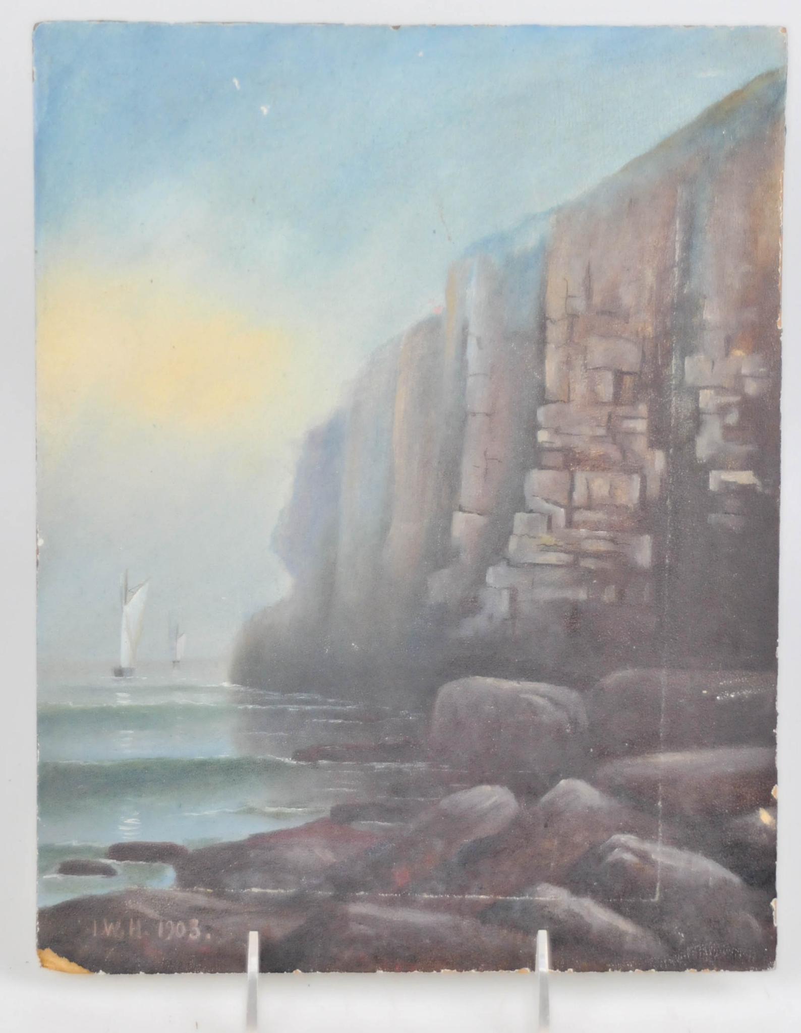 1903 OIL ON BOARD SAILING SHIP NEAR HIGH CLIFF OCEAN BEACH PAINTING: Measures 12" by 9 1/2". very high cliffs with a sailing vessel near a rocky shoreline beach. signed I.W.H. 1903. corners with minor damage. scratches on painting. painted on artist board. can 