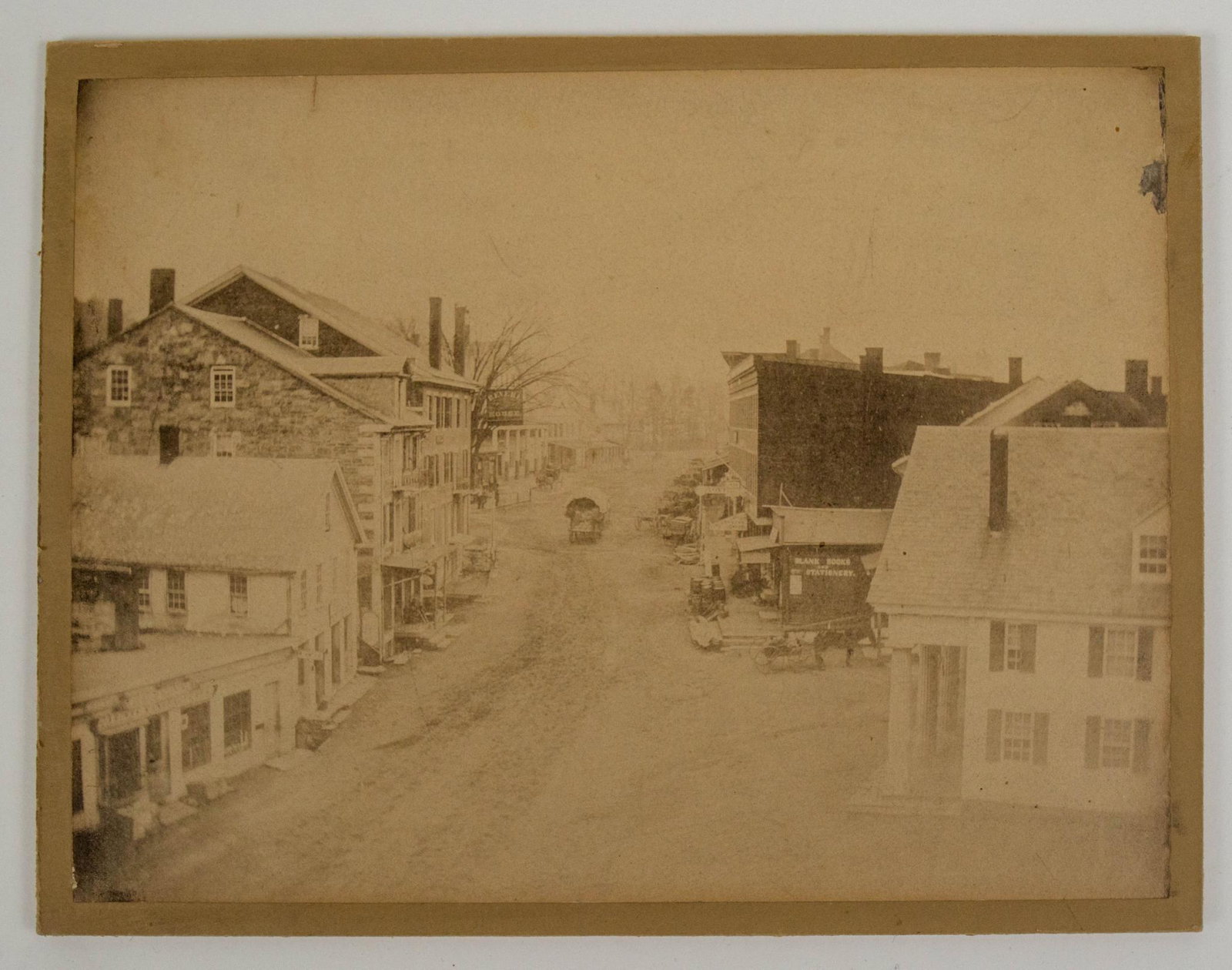 1860S VIEW BRATTLEBORO VERMONT MAIN ST PHOTOGRAPH REVERE HOUSE: This photograph is an 1860s view of Main St in Brattleboro Vermont prior to the fires. the photo has carriages moving through town and many business as well the Revere House. the businesses and buildi