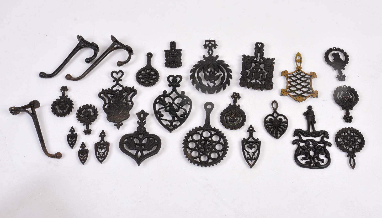 Large Collection of Cast Iron Hooks and Trivets. (1 of 2)