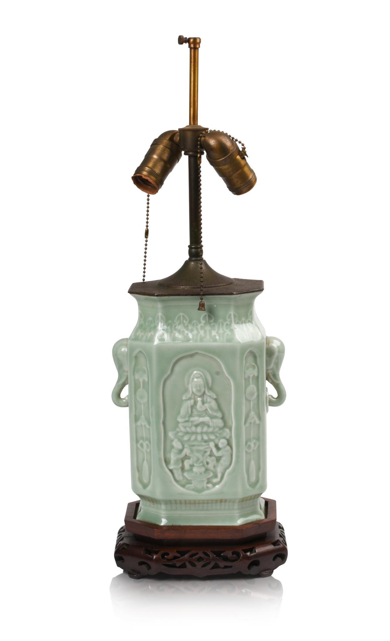 Chinese Celadon Glaze Porcelain Vase.: Guanyin depicted on front and back panel, elephant head handles, late 19th/early 20th c., mounted as lamp. Overall height 22.25 inches.