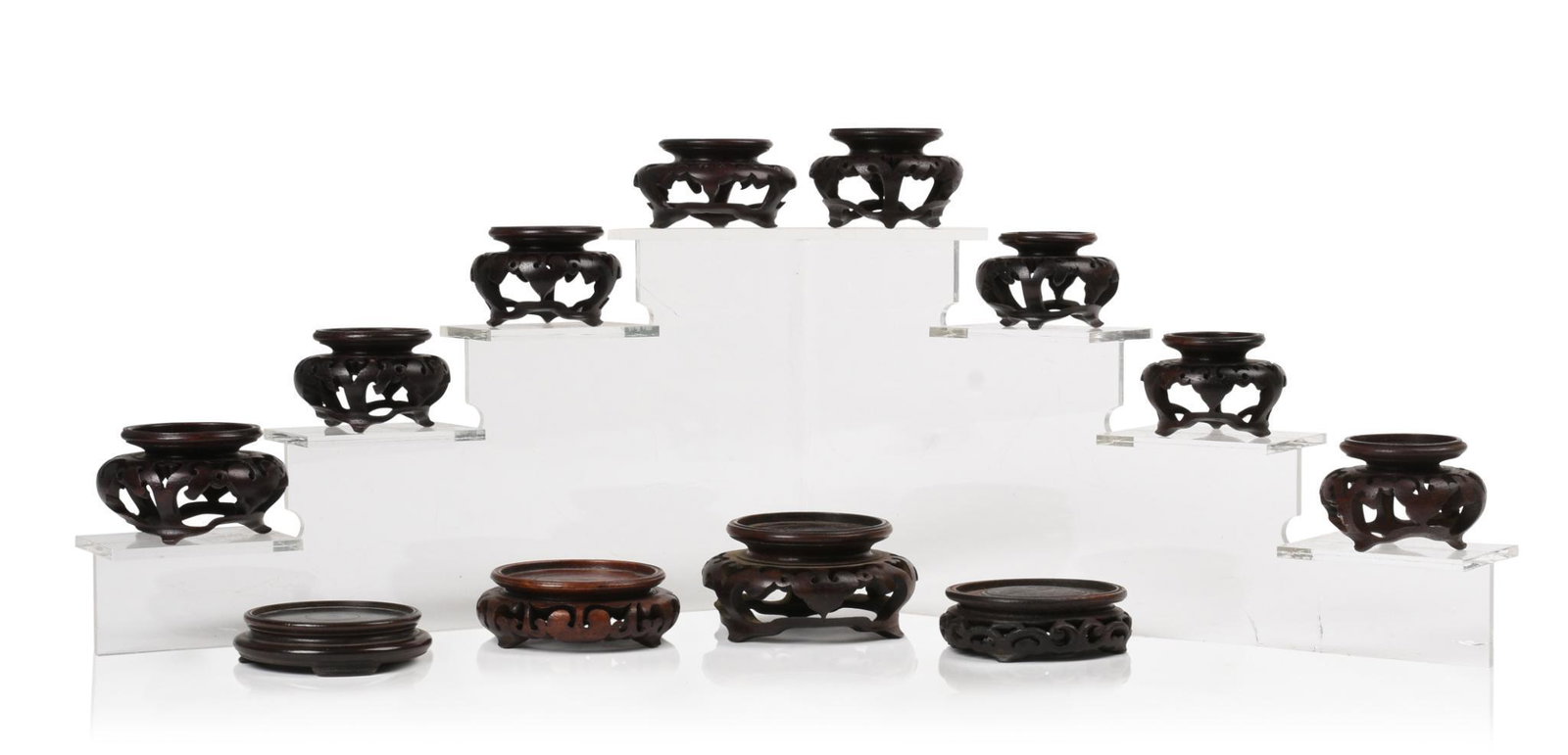 Twelve Chinese Carved Display Stands.: 20th c. Largest diameter 3.5 inches.