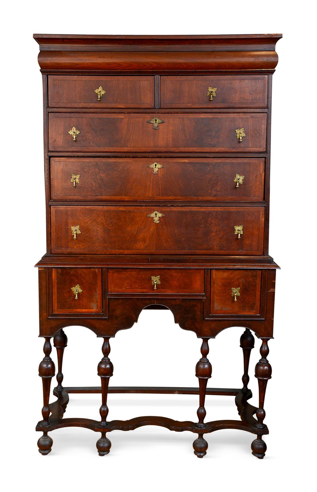 William and Mary Veneer Highboy.: Trumpet legs and scrolled base, circa 1720. Original brass tear drop pulls, top molded inset drawer. Height 68 inches, case width 36 inches, depth 17.5 inches.