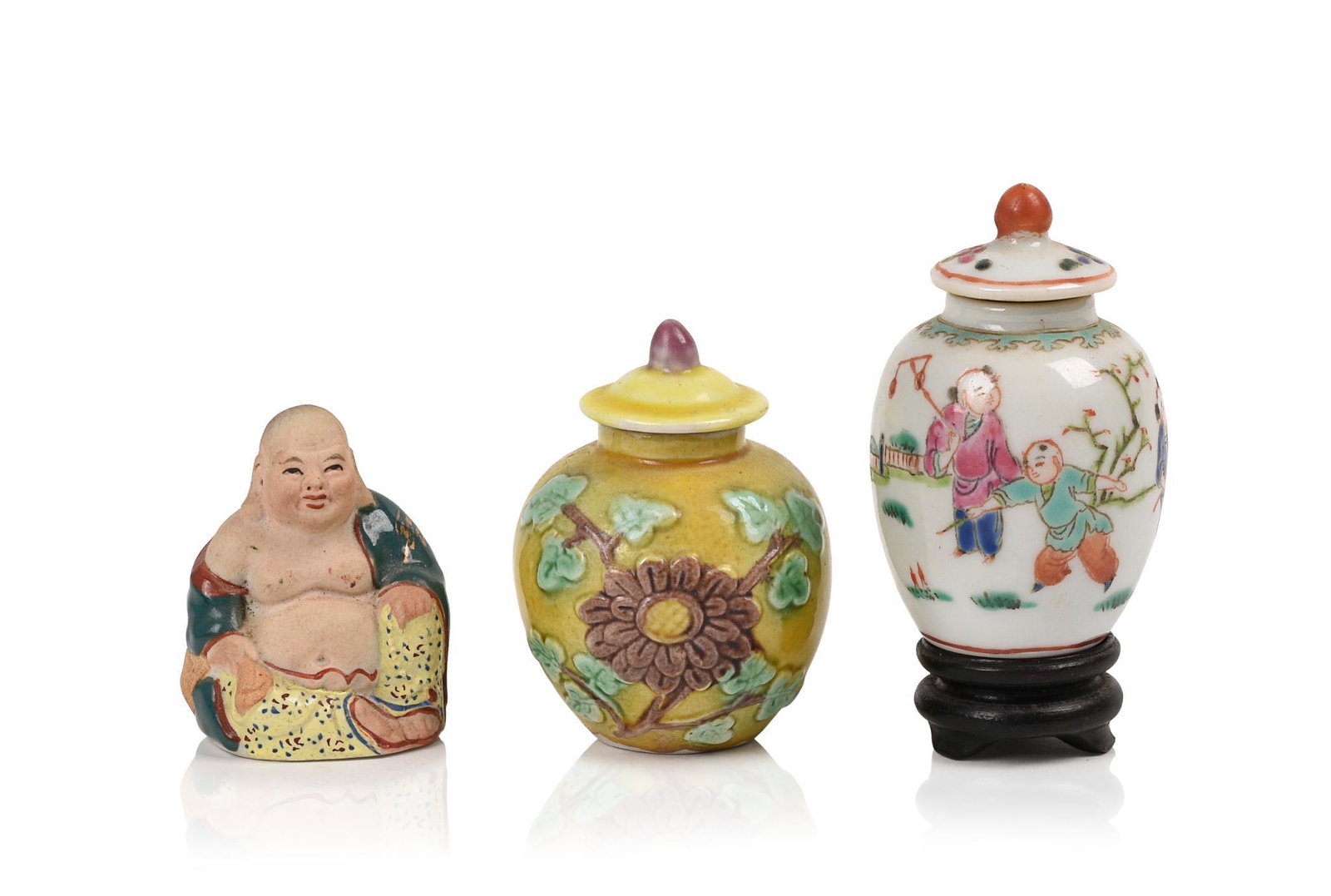 Three Small Chinese Porcelain Items.: Two covered jars, heights 2.5 and 3 inches, and a Buddha.