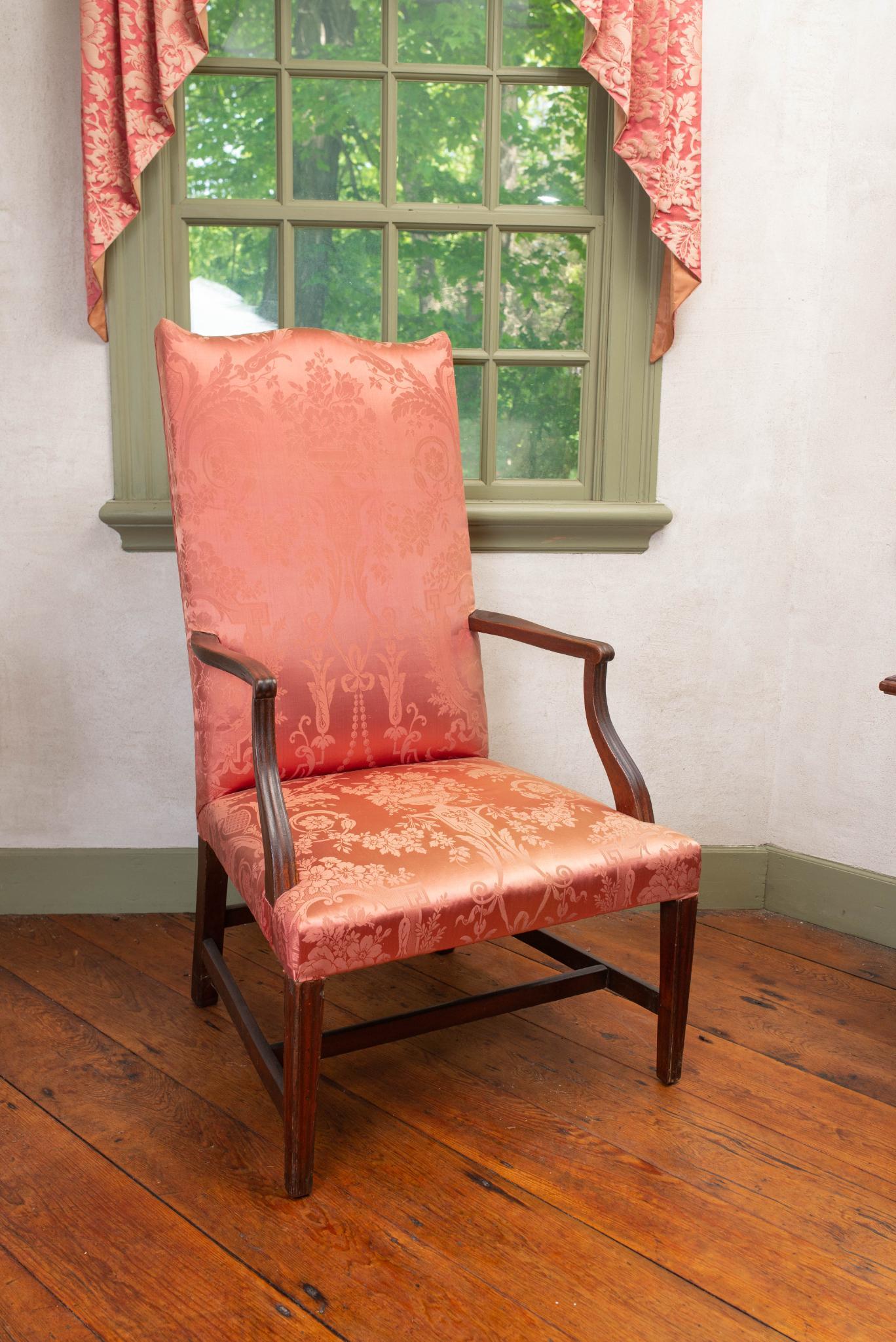 MAHOGANY HEPPLEWHITE LOLLING CHAIR.: With molded legs and red upholstery, New England. Circa 1750-65, Provenance - Mary Walton's personal chair. 25 3/4" wide, 44 1/4 " high, 28" deep CONDITION: In good structural conditio