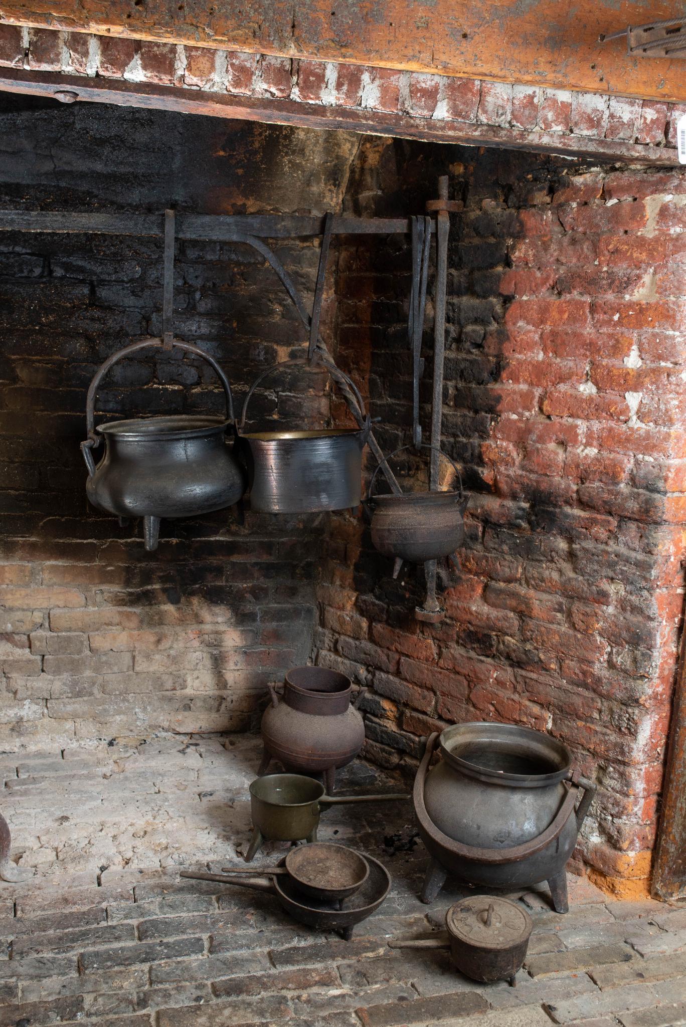 NINE EARLY BRONZE, BRASS AND CAST IRON POTS. (1 of 1)