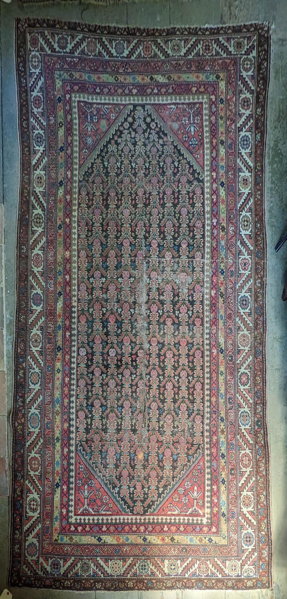 ORIENTAL RUG WITH RED AND BROWN FIELD. (1 of 4)