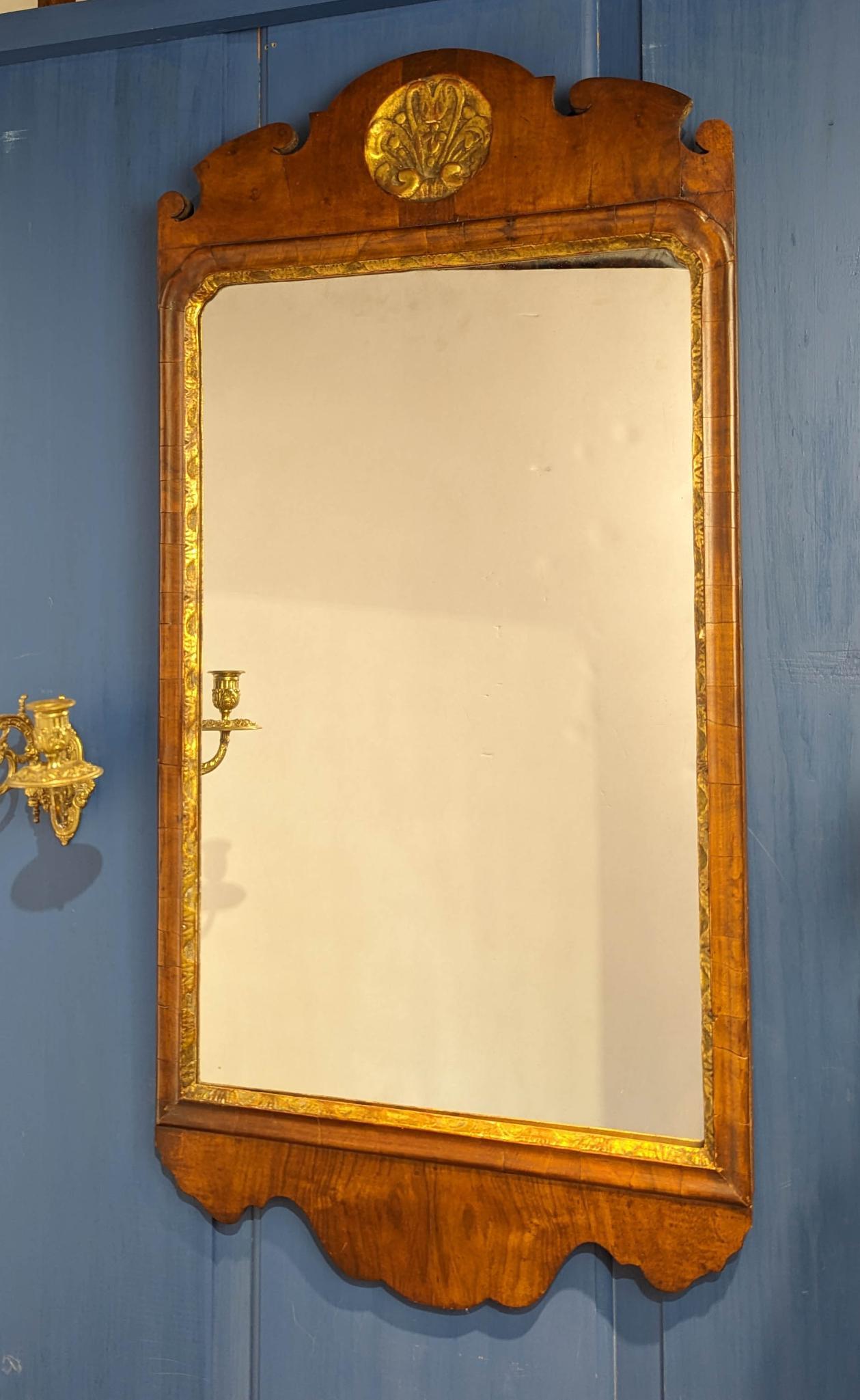 18TH CENTURY MAHOGANY AND GILT MIRROR.: Wth carved and gilt shell. Overall 38.75 x 18.75 inches. CONDITION: Good antique condition. Replaced mirror glass.