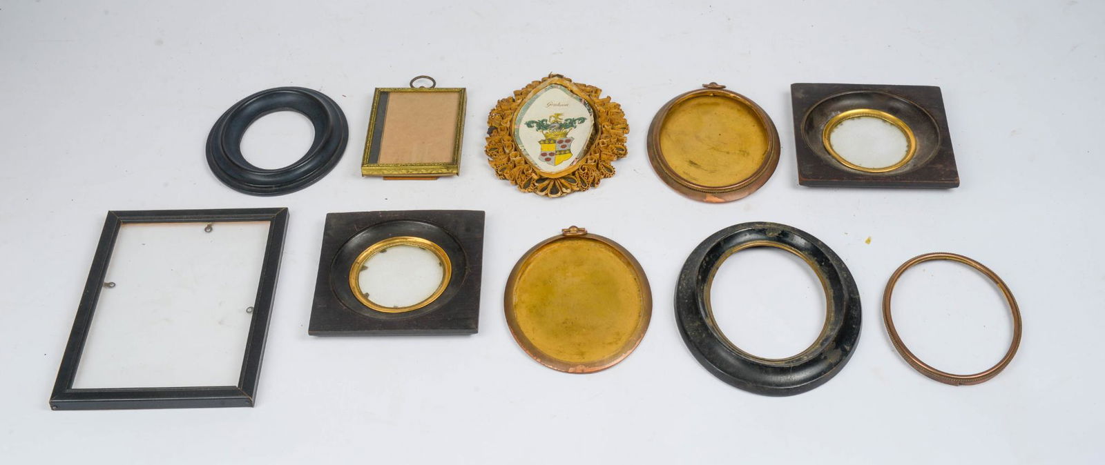 EIGHT SMALL PICTURE FRAMES FOR MINIATURES.: Together with an extensive group of brass frames for miniatures. Oval, round, square. Approx. 5 to 7 inches. Wood & metal examples.
