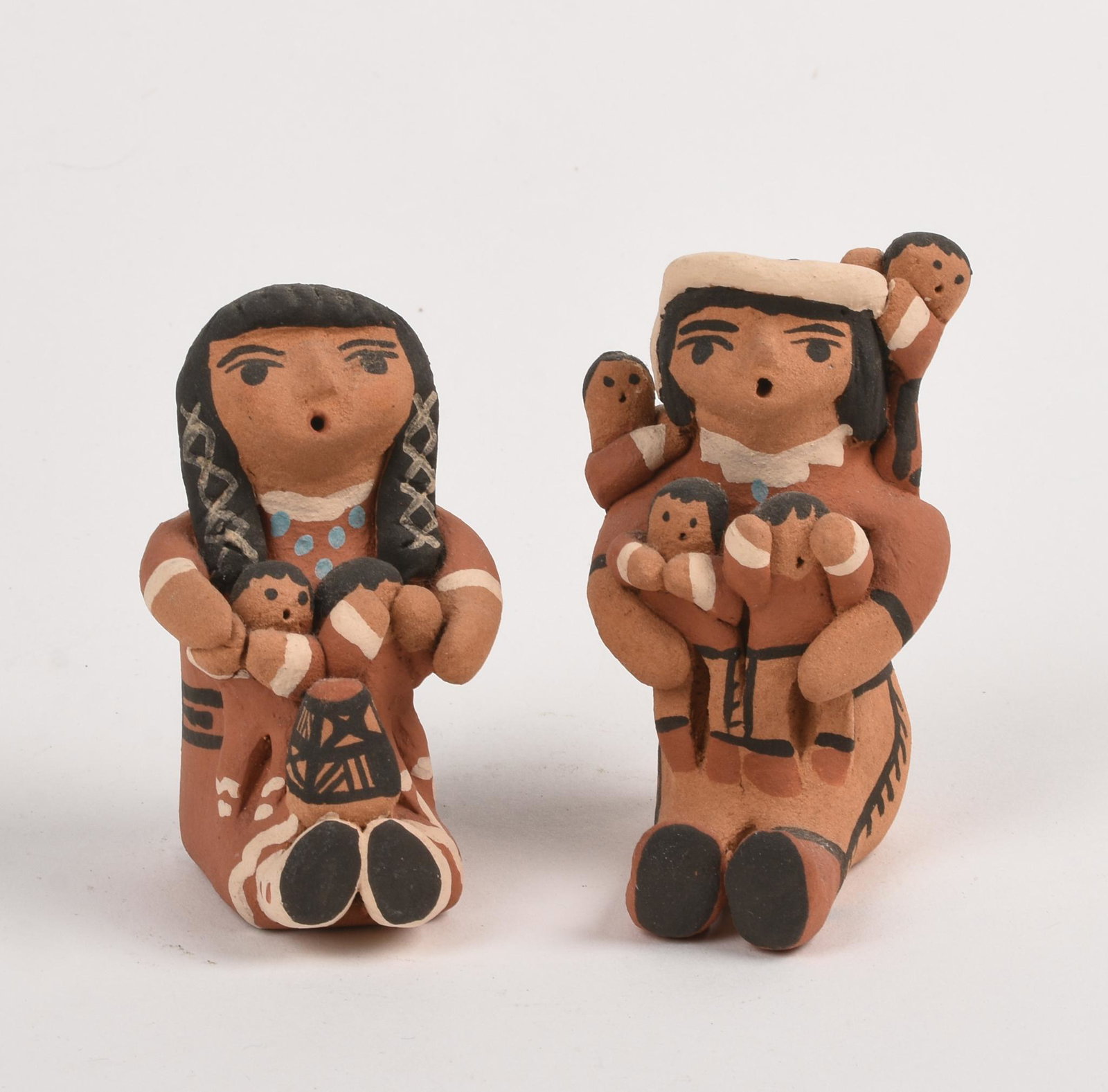 Two FL Jemez Storyteller Figurines.: Signed. Red clay. Height of taller 3.5 inches.
