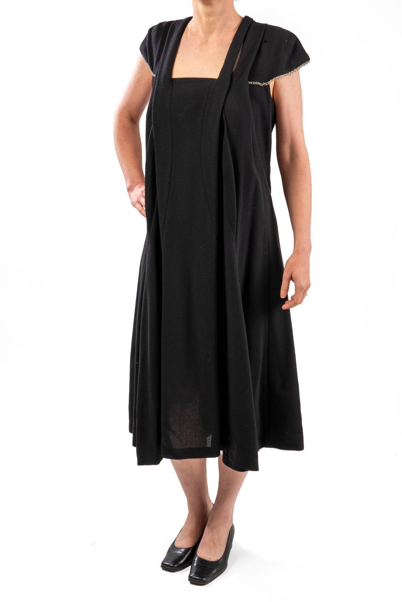 Yves Saint Laurent Wool Cocktail Dress, F38: Size F38, possibly vintage, Bback, silvertone chain detailing on cap sleeves. Resale Tag for $1419 CONDITION:These are used articles, and may exhibit minor stains, wear, slight odors, and other minor