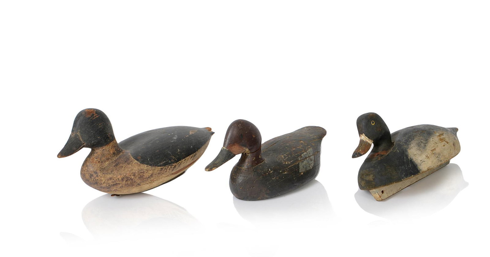 Three Carved and Painted Duck Decoys.: Lengths 13 to 14 inches.