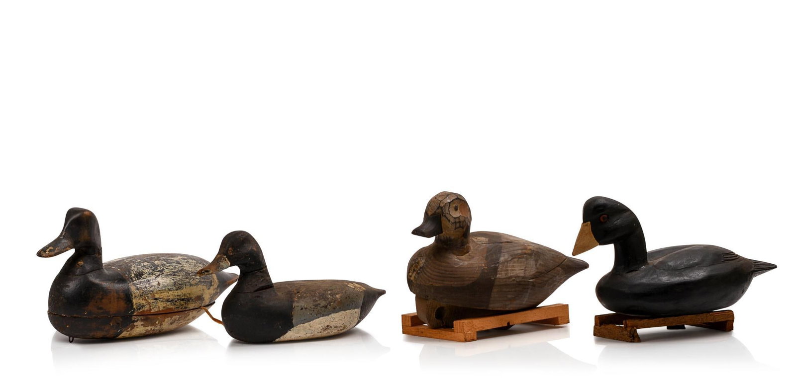 Four Antique Duck Decoys.: One by Bourg Lewis the others unmarked lengths 11 to 13 inches.