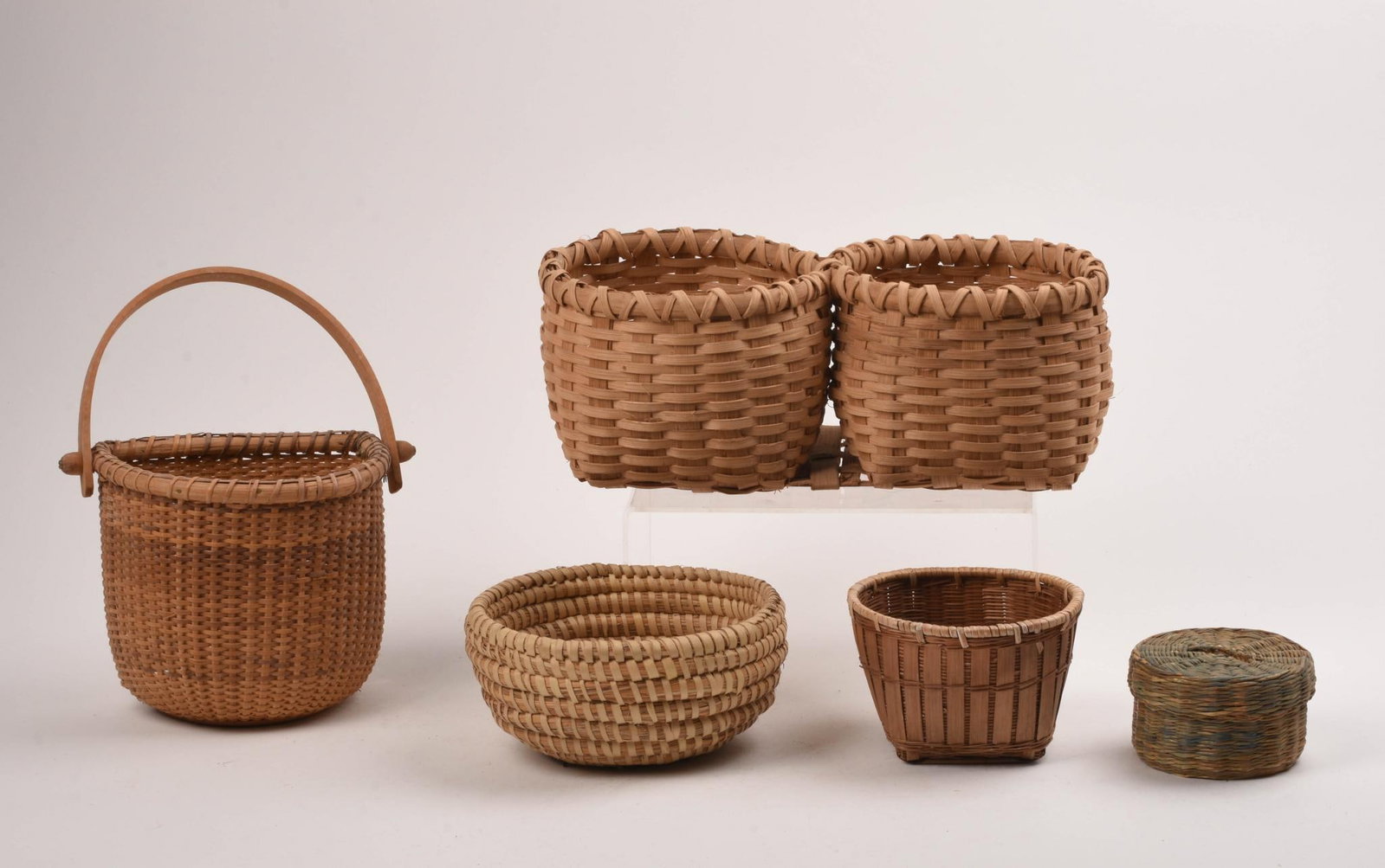 Group of Baskets.: A double basket, width 11 inches, coiled sweetgrass, and other examples. Five total
