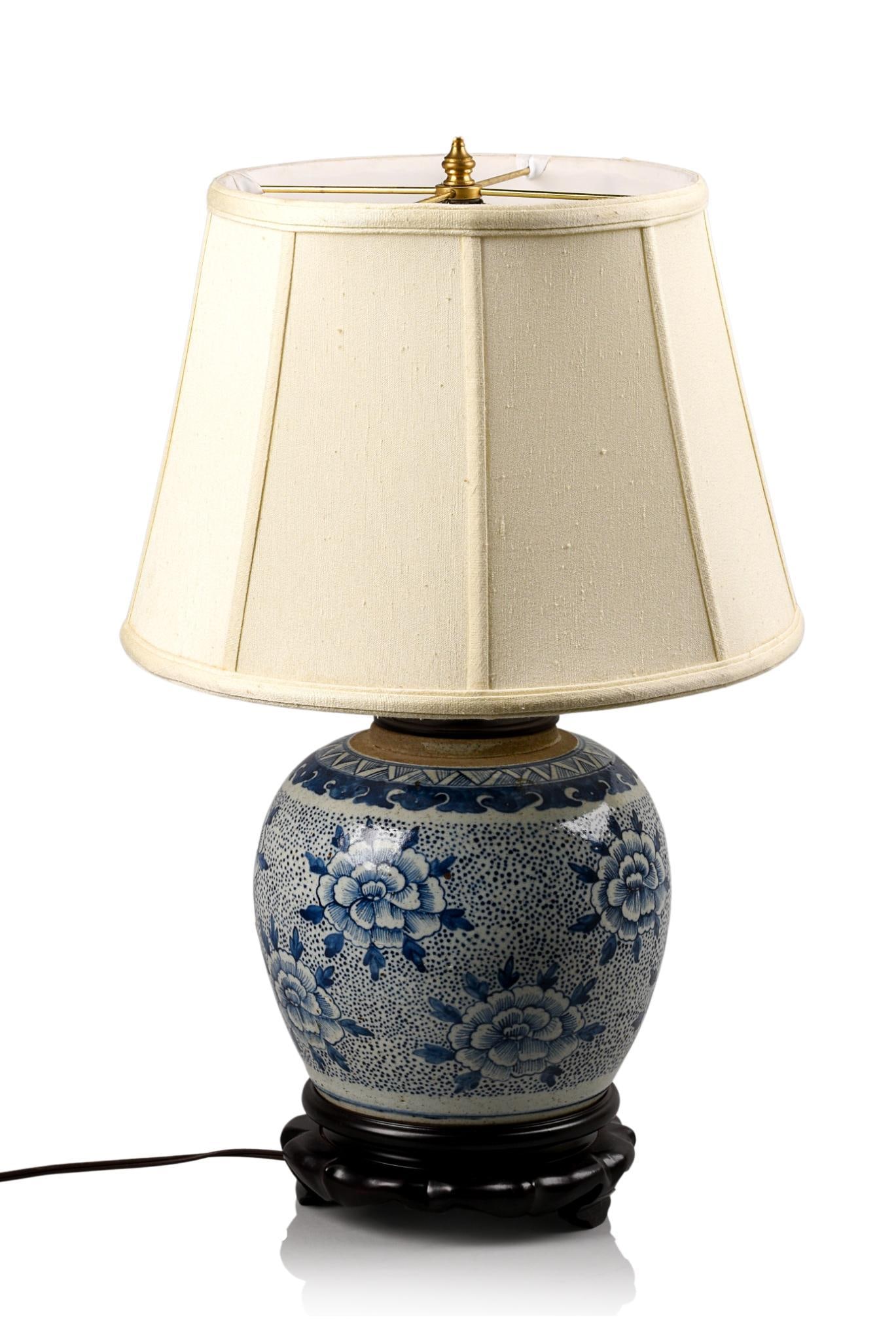 FLORAL DECORATED BLUE AND WHITE GINGER JAR LAMP: On wood base with silk shade, height without shade 15.5 inches