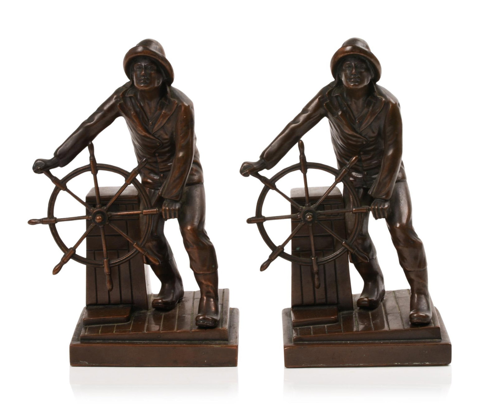 PAIR OF LEONARD CRASKE SAILOR BOOKENDS.: Height 9 inches, patinated bell metal or bronze, minor bend to one ship's wheel.