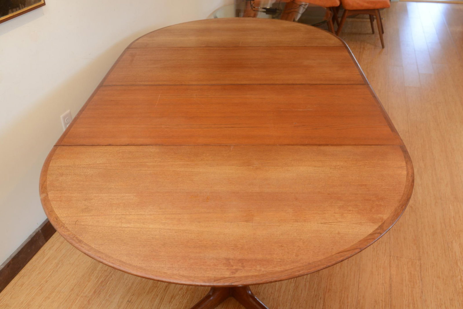 Danish Modern Teak Dining Table: Height 28 inches, diameter 47 inches. With two leaves, each leaf 20 inches. Total length with leaves 87 inches.