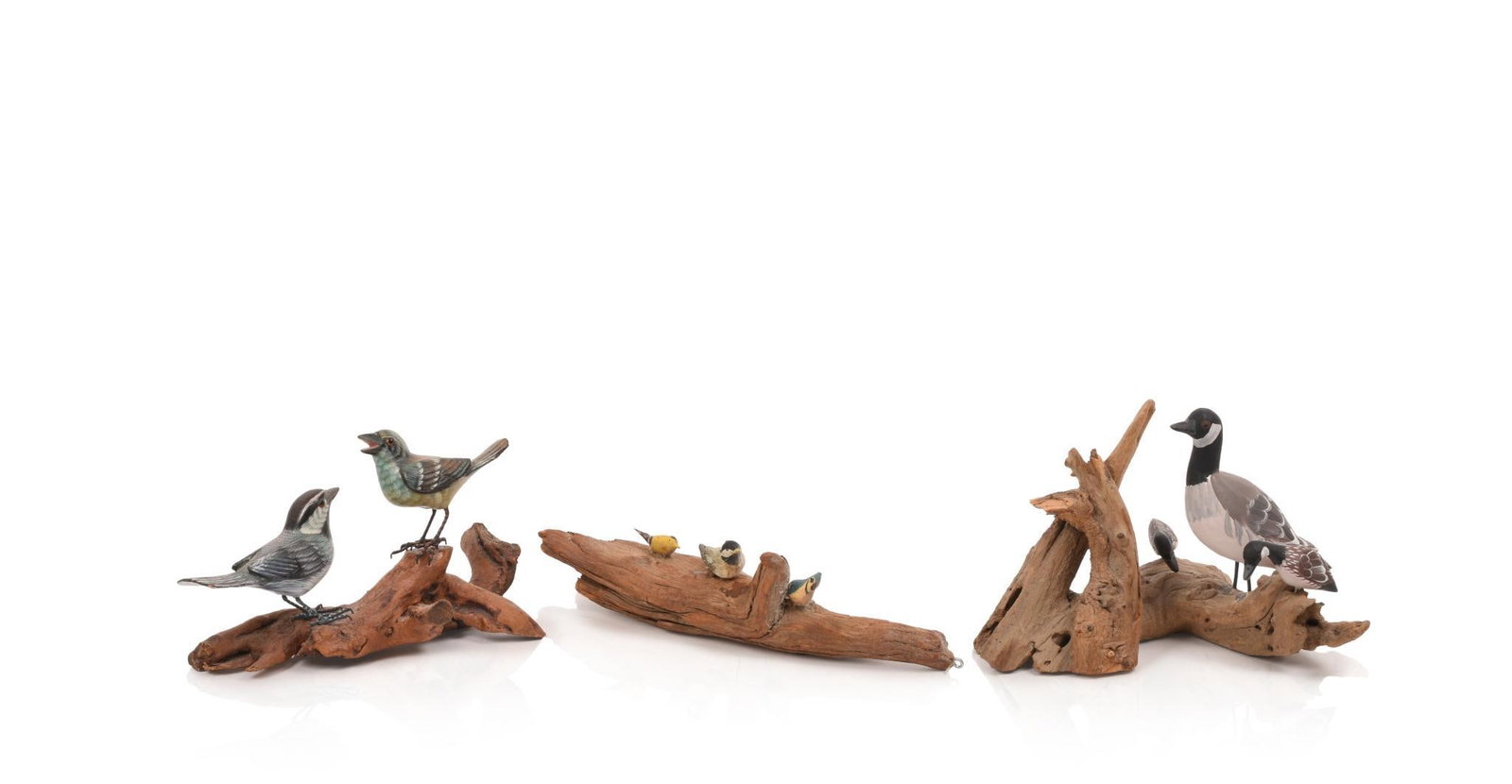 THREE CARVED MANTLE BIRD GROUPS ON DRIFTWOOD BASES.: Canada geese, length 8 inches, a pair of songbirds, and three songbirds.