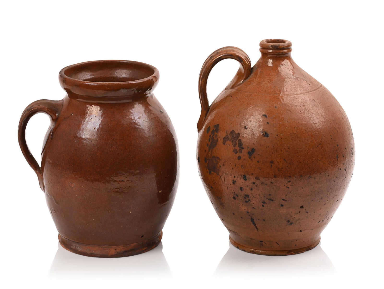 19th Century Redware Jar and a Jug: Height 8 inches. Some small chips at foot and rim of jar, surface loss and chips to jug.