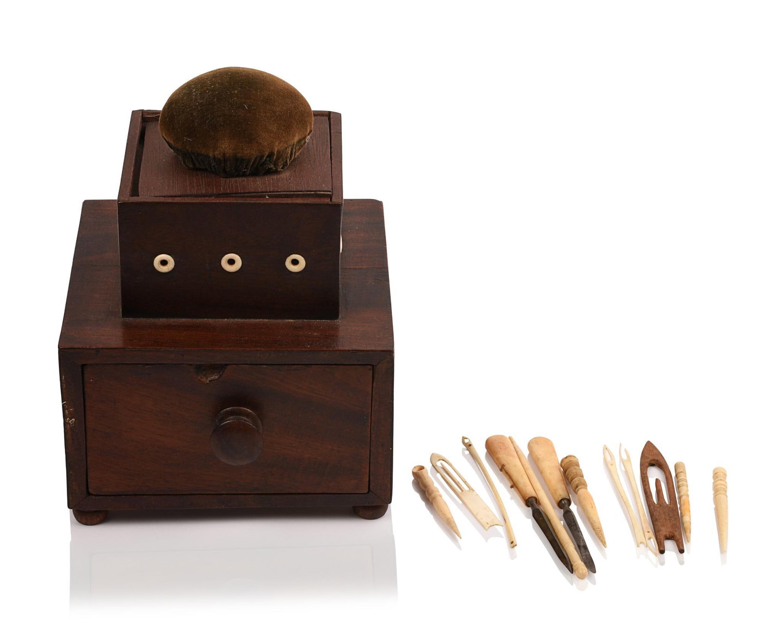 19TH CENTURY SINGLE DRAWER, STEPPED SEWING BOX AND PINCUSHION.: The top section has a spool holder. Contents include: 4 whalebone bodkins, a whalebone crochet hook, a variety of shuttles and two bone handle tools (12 pieces). Size: 6? square
