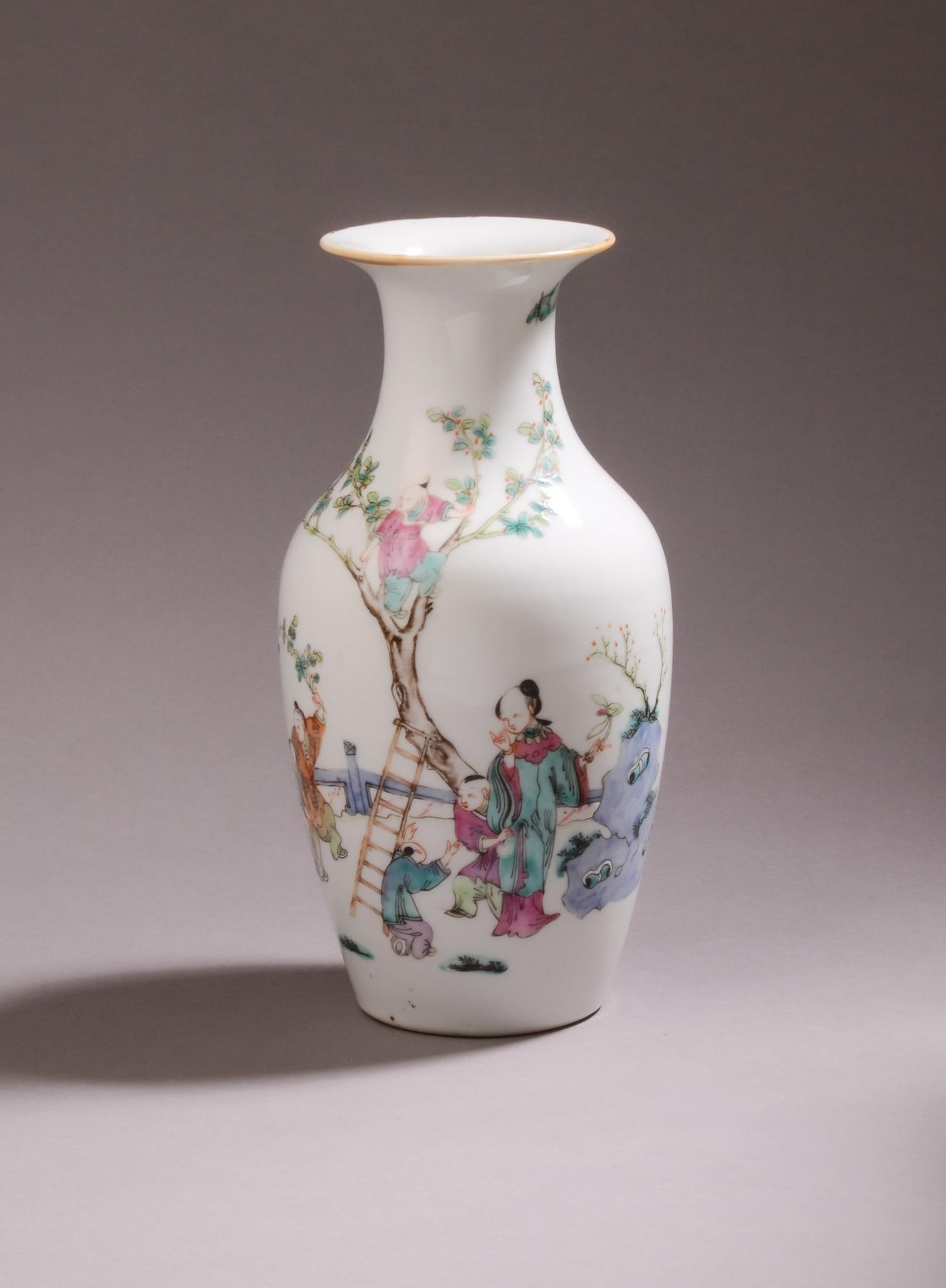 Chinese Famille Rose Porcelain Boys Vase.: Depicts five boys with a lady playing around a tree. Tongzhi mark, 19th c. Small spot of enamel loss on lady's robe. Height 9 inches.