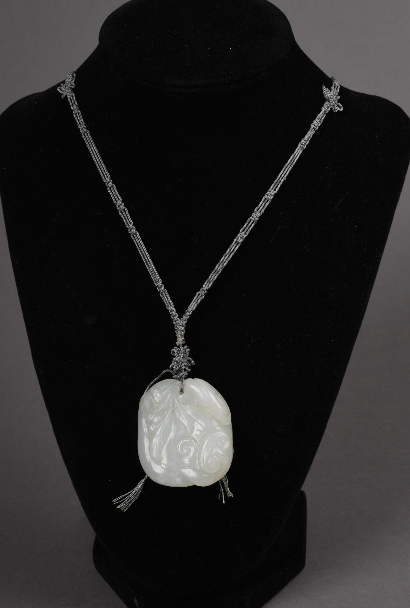 Chinese Carved White Jade Peach and Lingzhi Amulet: 19th century with blue silk cord. Length 30 inches.