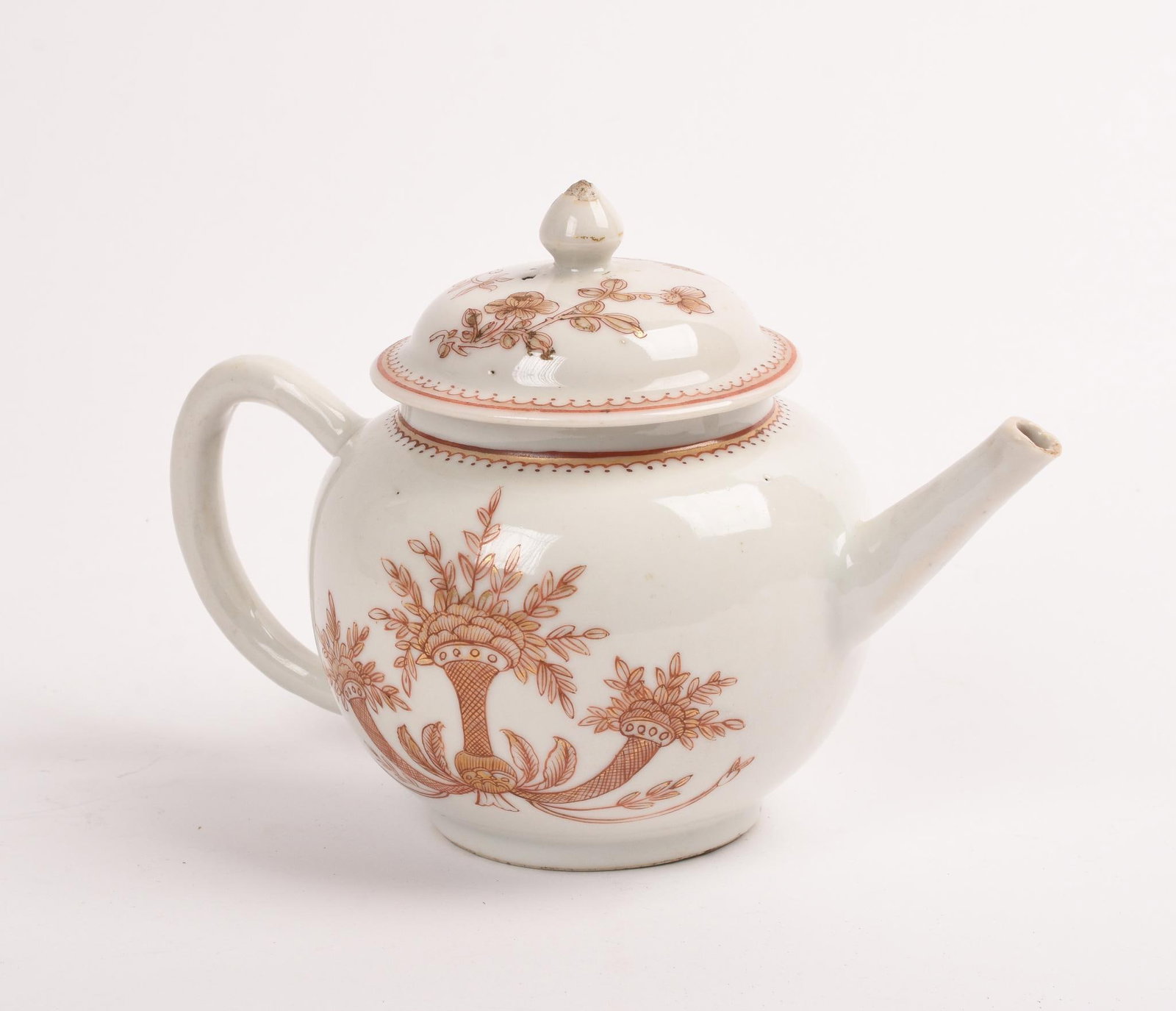 Chinese Export Porcelain Teapot: 18th c., red and gilt decoration of a basket and two cornucopias of flowers. Elinor Gordon label on underside of lid. Height 5 inches, width 7 inches. Minor loss to spout and lid finial.
